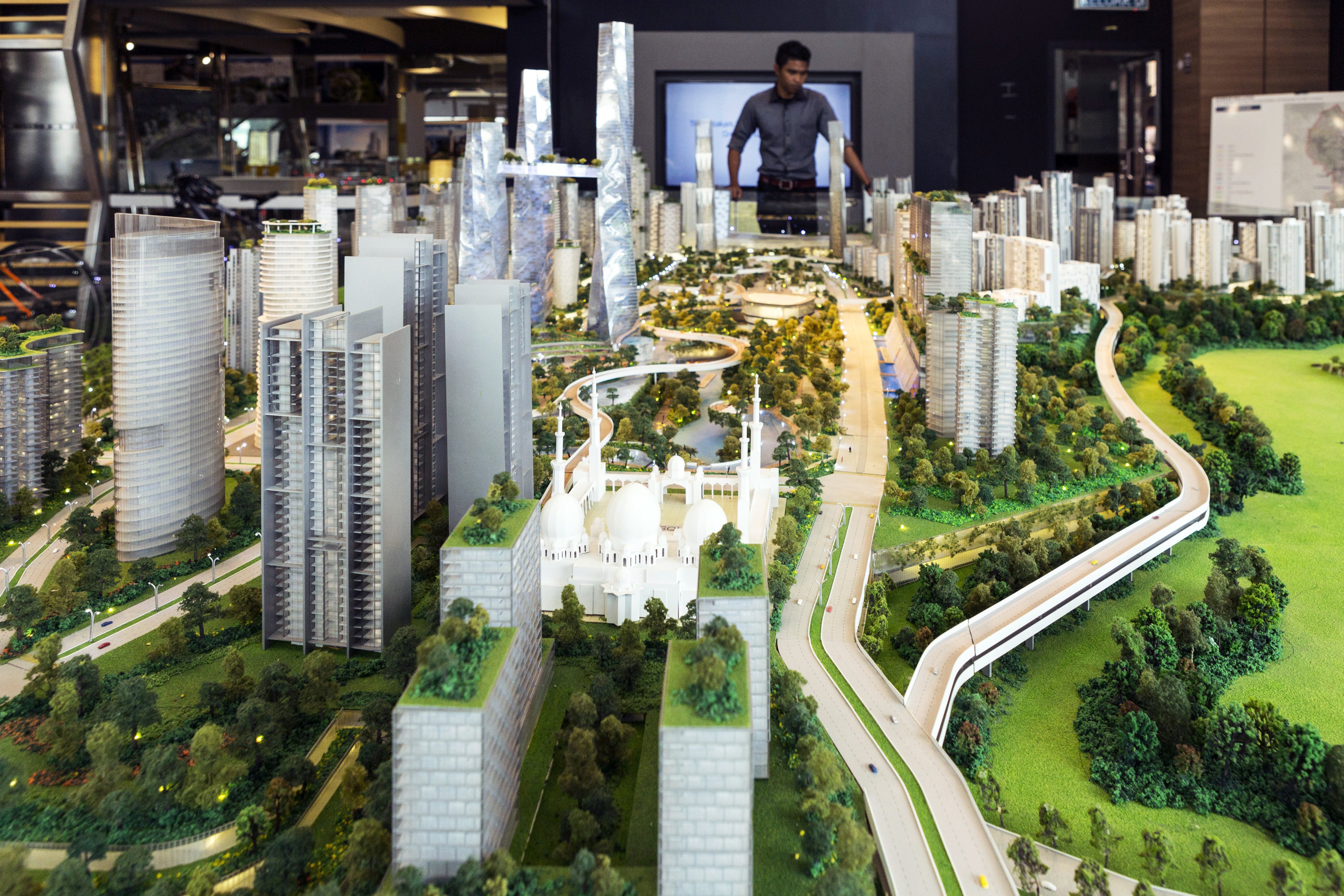 A visitor looks at a model of the proposed Bandar Malaysia development in 2016. PM Anwar Ibrahim’s government in October 2023 said it would take over the project, after a slew of aborted attempts by the previous developer. Photo: Bloomberg