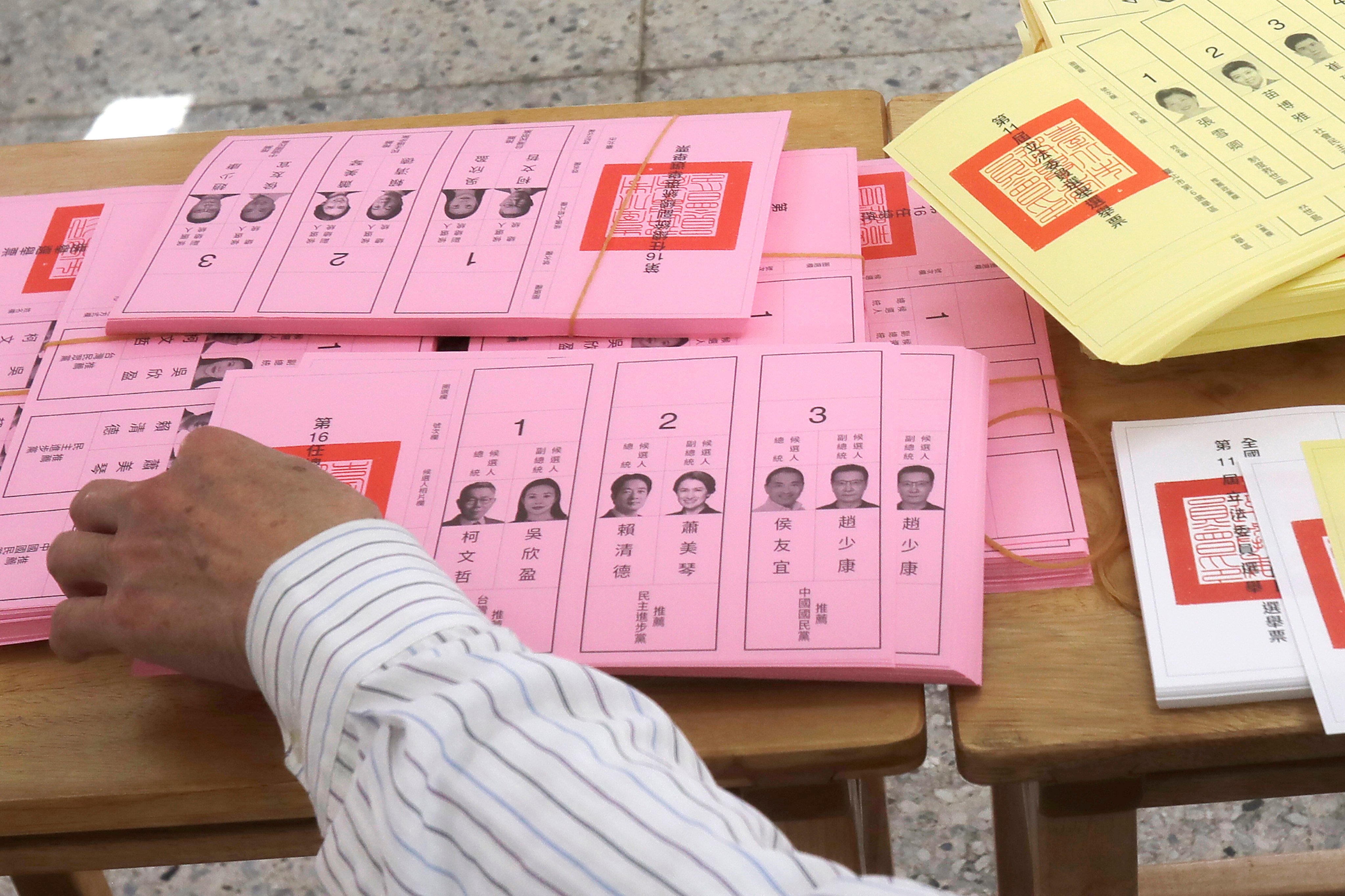 A poll worker sorts ballots in Taipei, Taiwan on Saturday. Photo: AP