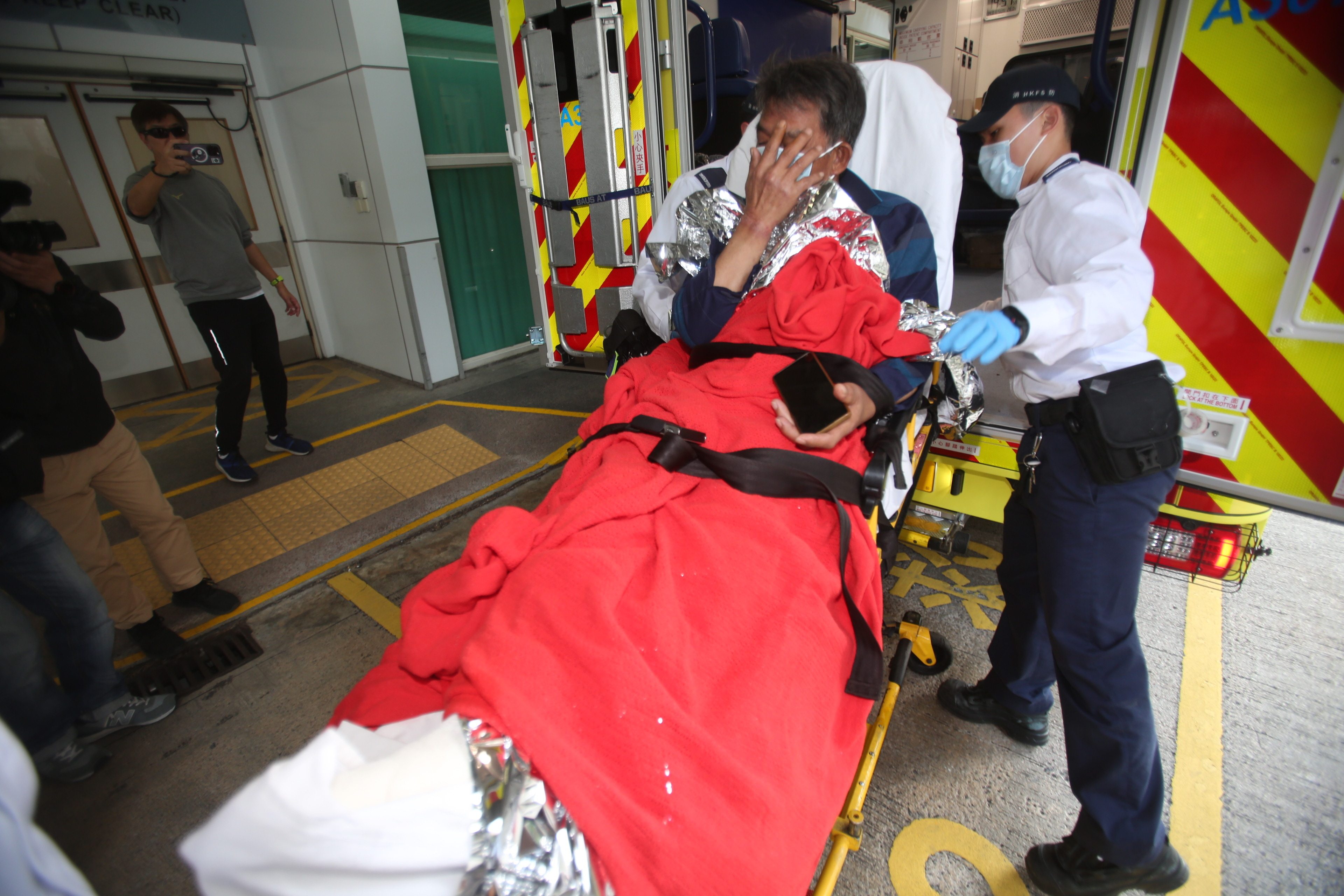 The brother who survived is taken to Pamela Youde Nethersole Eastern Hospital in Chai Wan. Photo: Handout