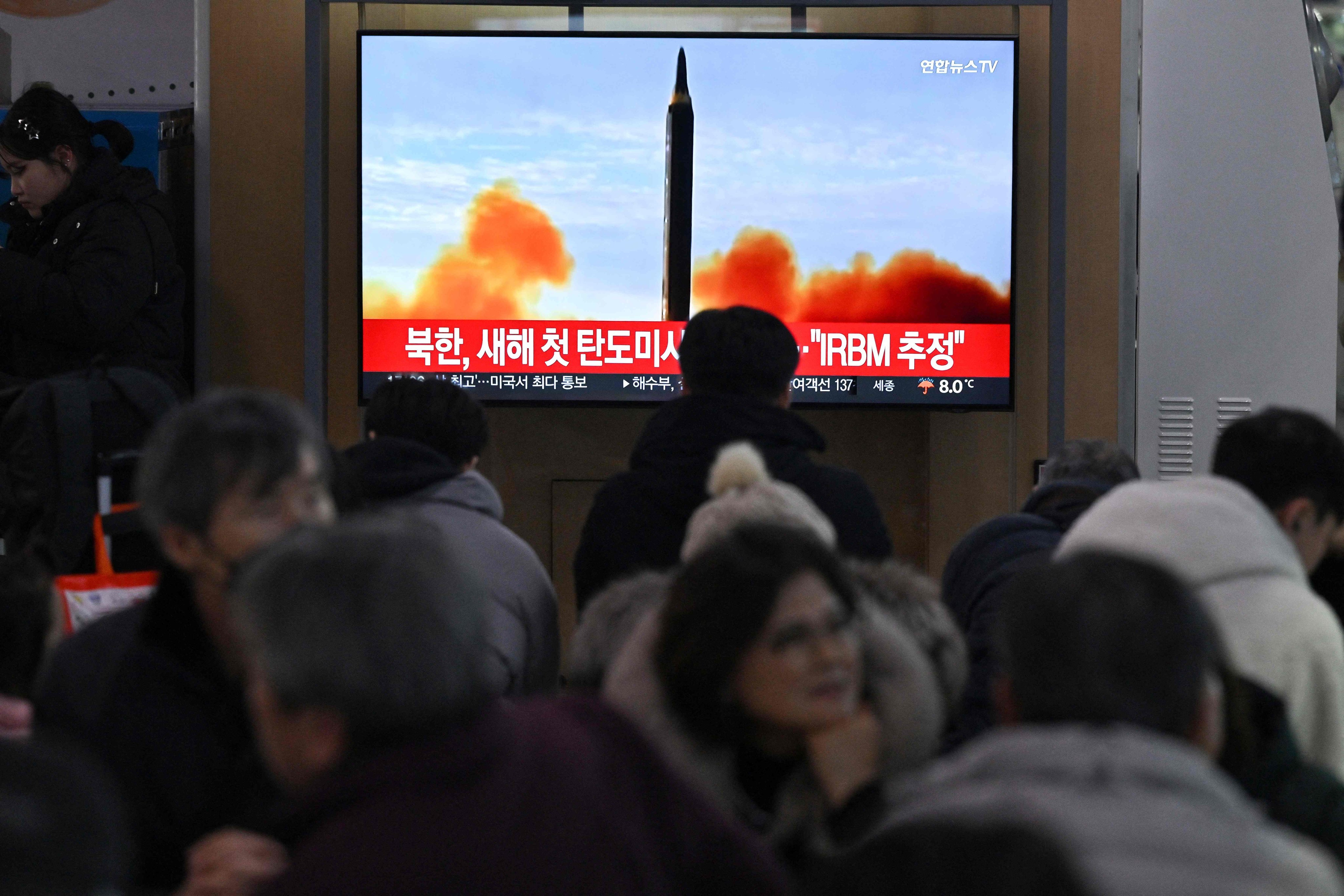 People watching a news broadcast with file footage of a North Korean missile test at a railway station in Seoul on January 14 after the North fired a ballistic missile on the same day. Photo: AFP