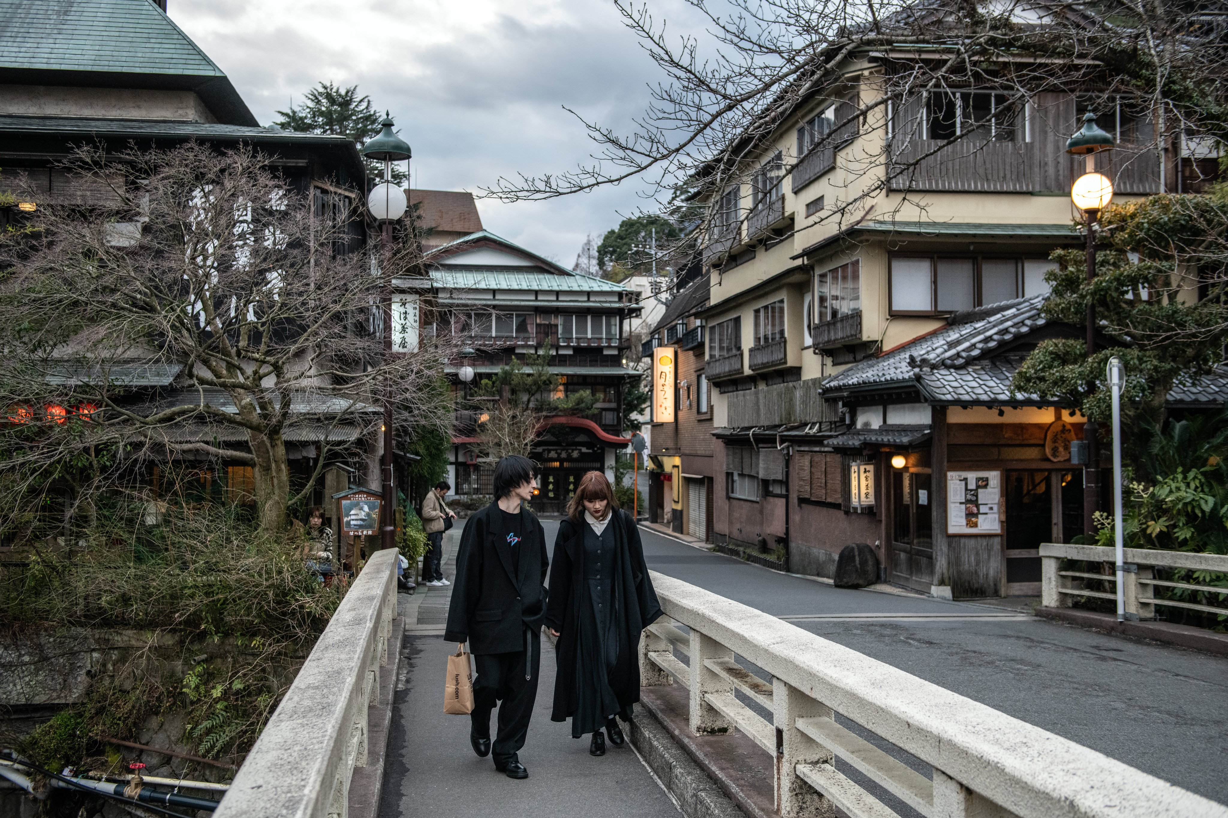 A couple walk over a bridge in Hakone, Japan. Hotels in the hot spring resort and elsewhere around the country are dealing with a surge in visitors. Photo: Getty Images