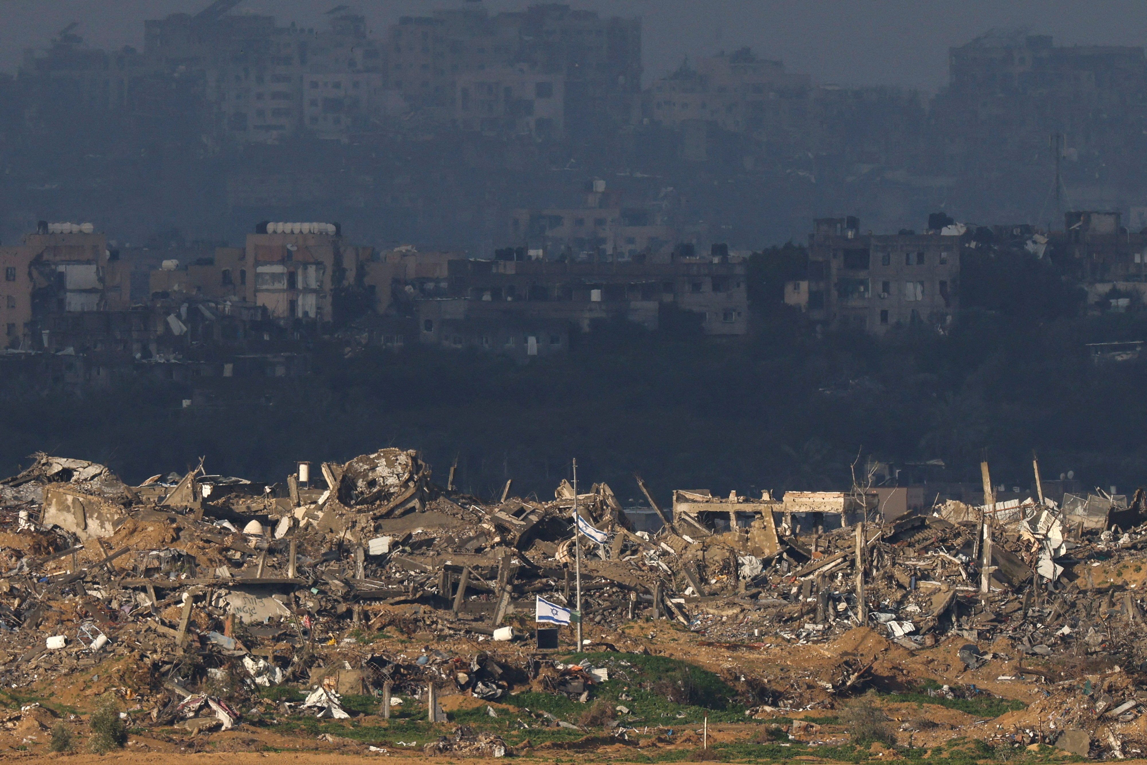 Israeli flags flutter in Gaza, as seen from Israel. Photo: Reuters