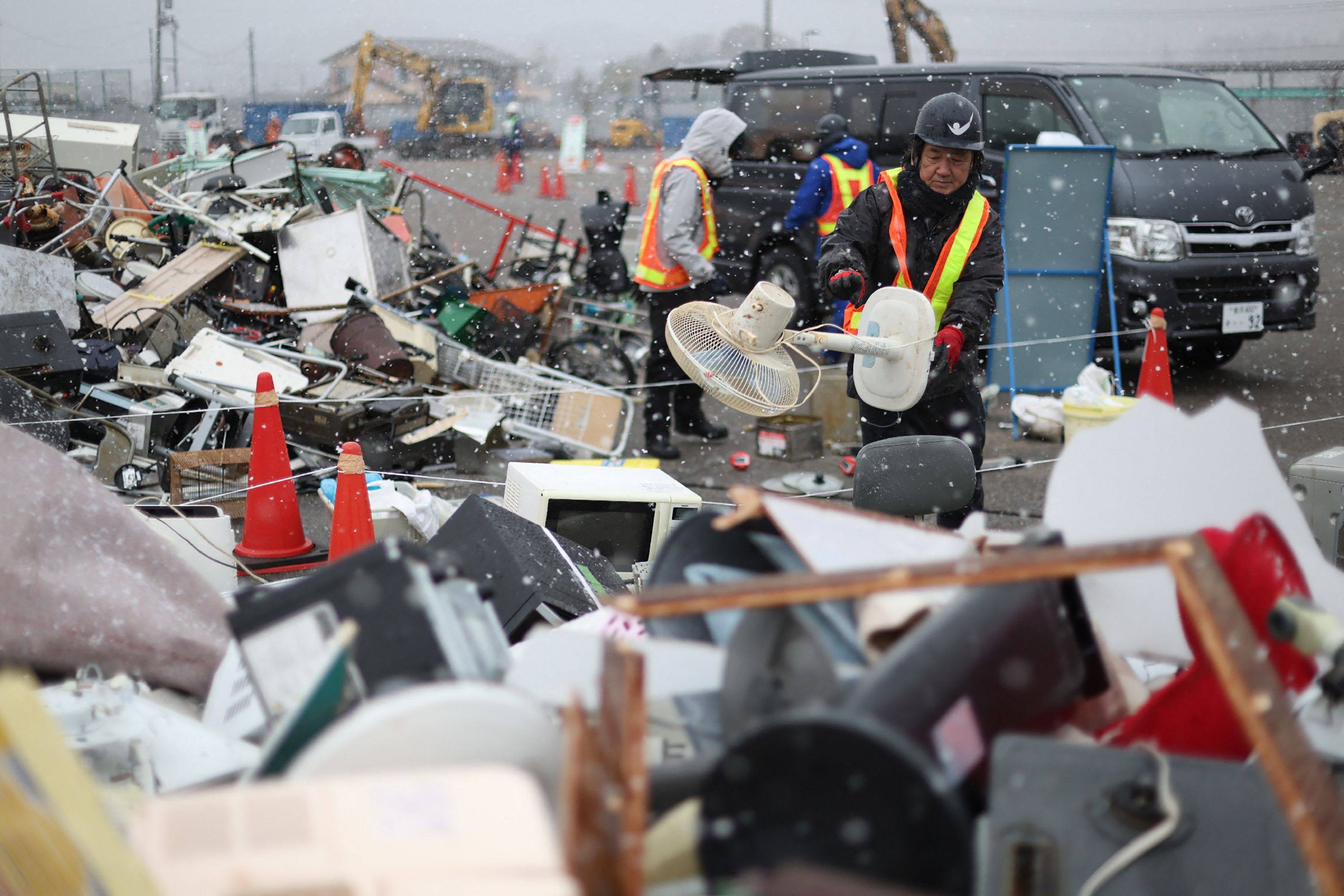 Men work at a disaster waste collection site in Nanao, Ishikawa prefecture on January 15. Photo: AFP