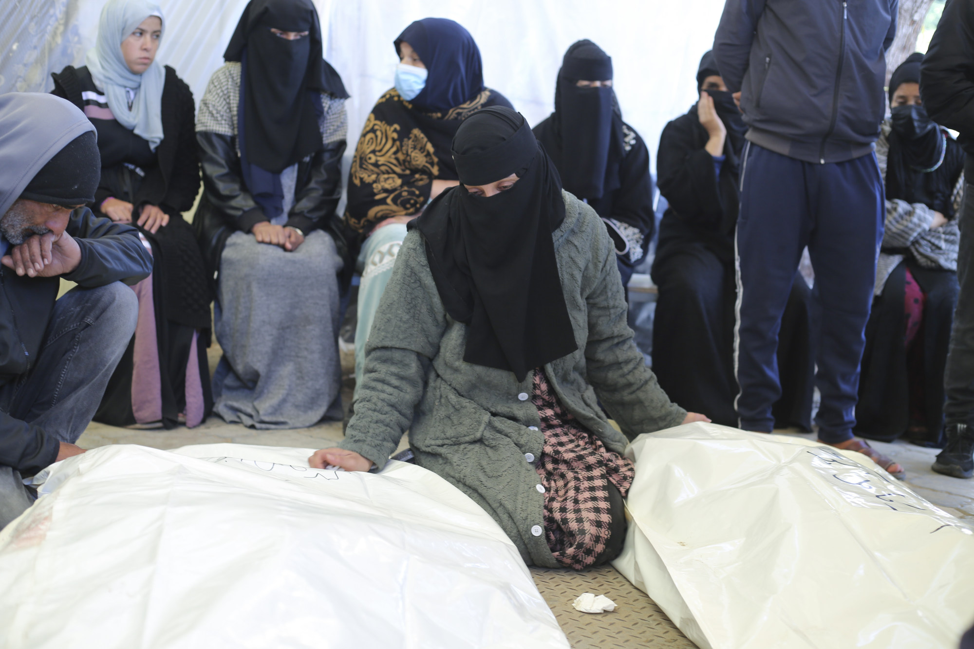A Palestinian woman mourns relatives killed in the Israeli bombardment of the Gaza Strip in a morgue at hospital in Khan Younis on Tuesday. Photo: AP