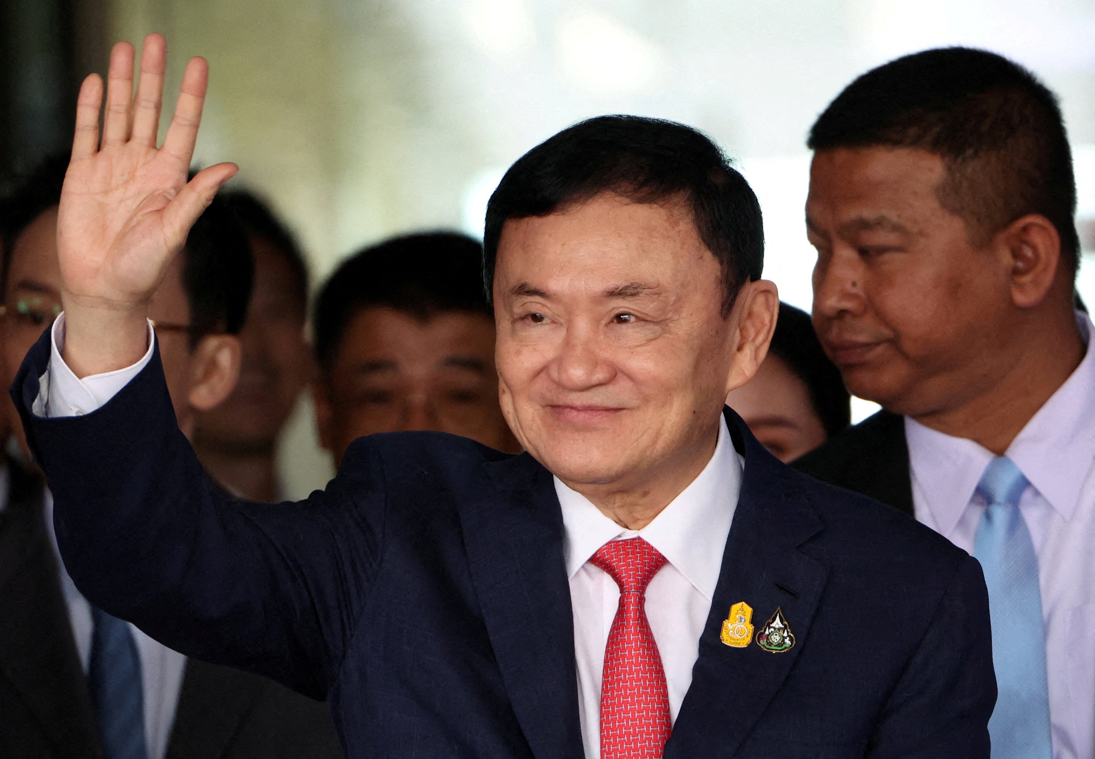 Former Thai prime minister Thaksin Shinawatra waves at Don Mueang airport in Bangkok on August 22. Photo: Reuters