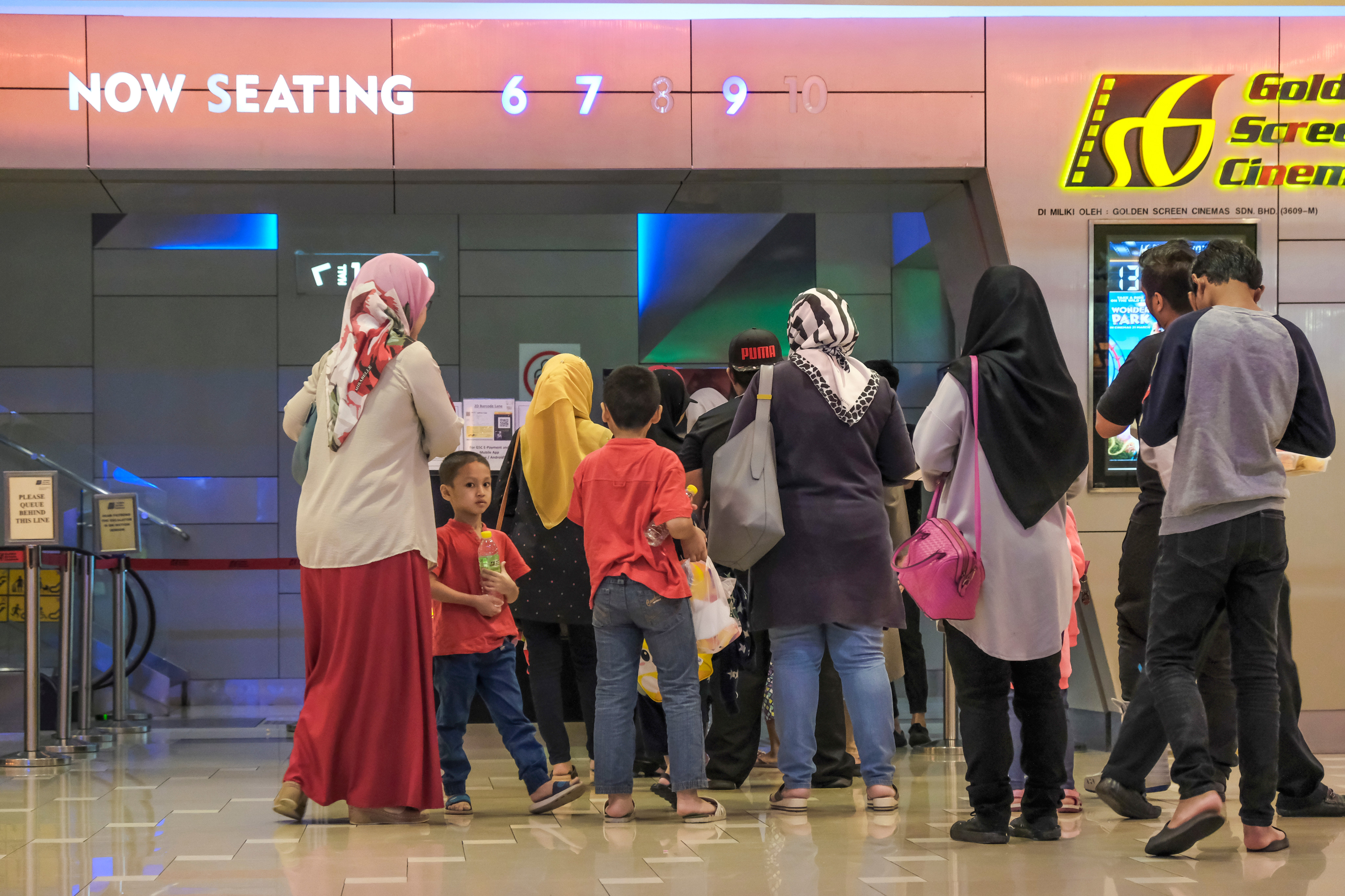 People waiting to enter the GSC cinema in Palm Mall shopping complex in Seremban, Malaysia. Photo: Shutterstock
