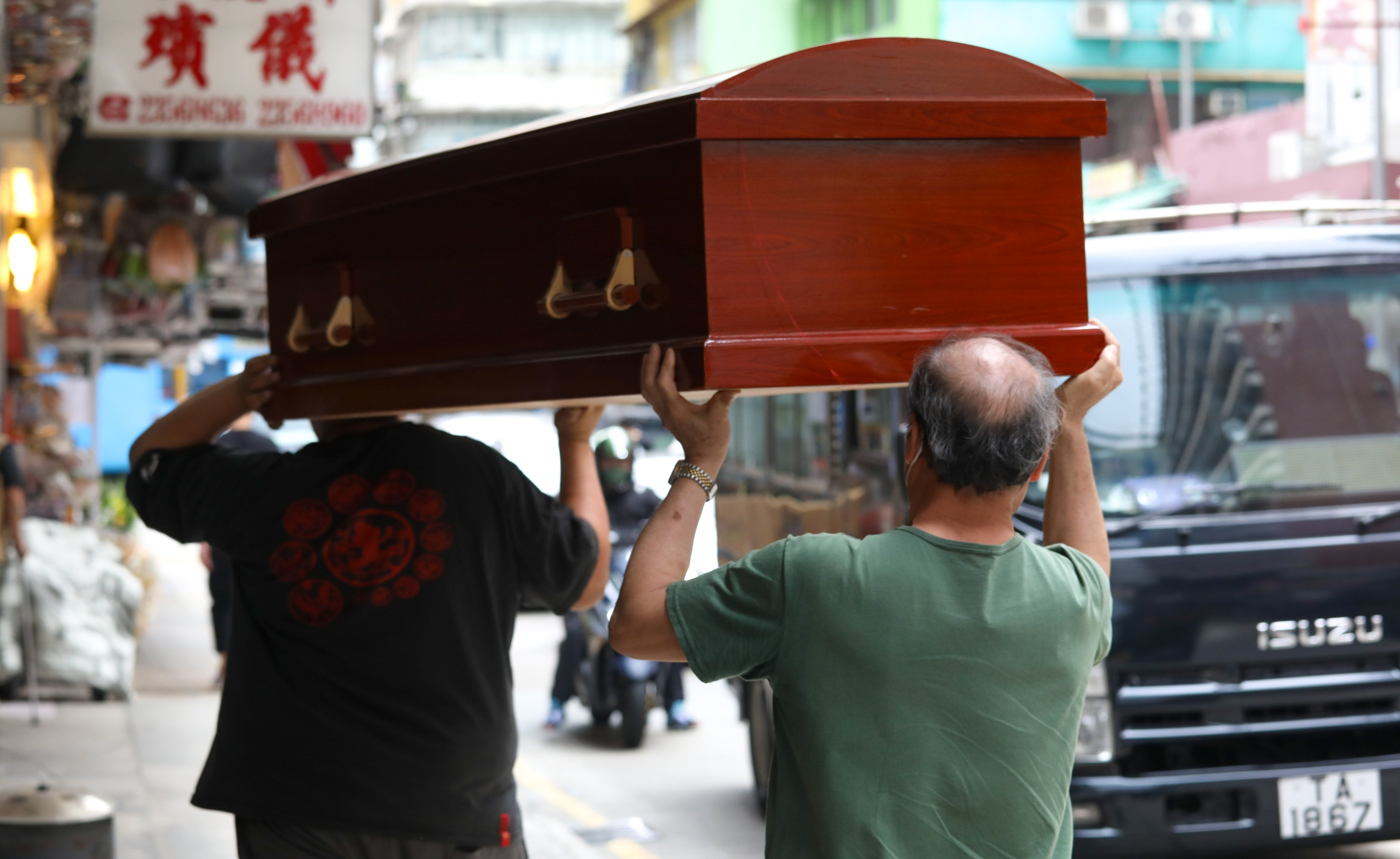 Funeral service staff carry a coffin in Hung Hom. Hong Kong’s antitrust watchdog raided several businesses in the area on Wednesday. Photo: Yik Yeung-man