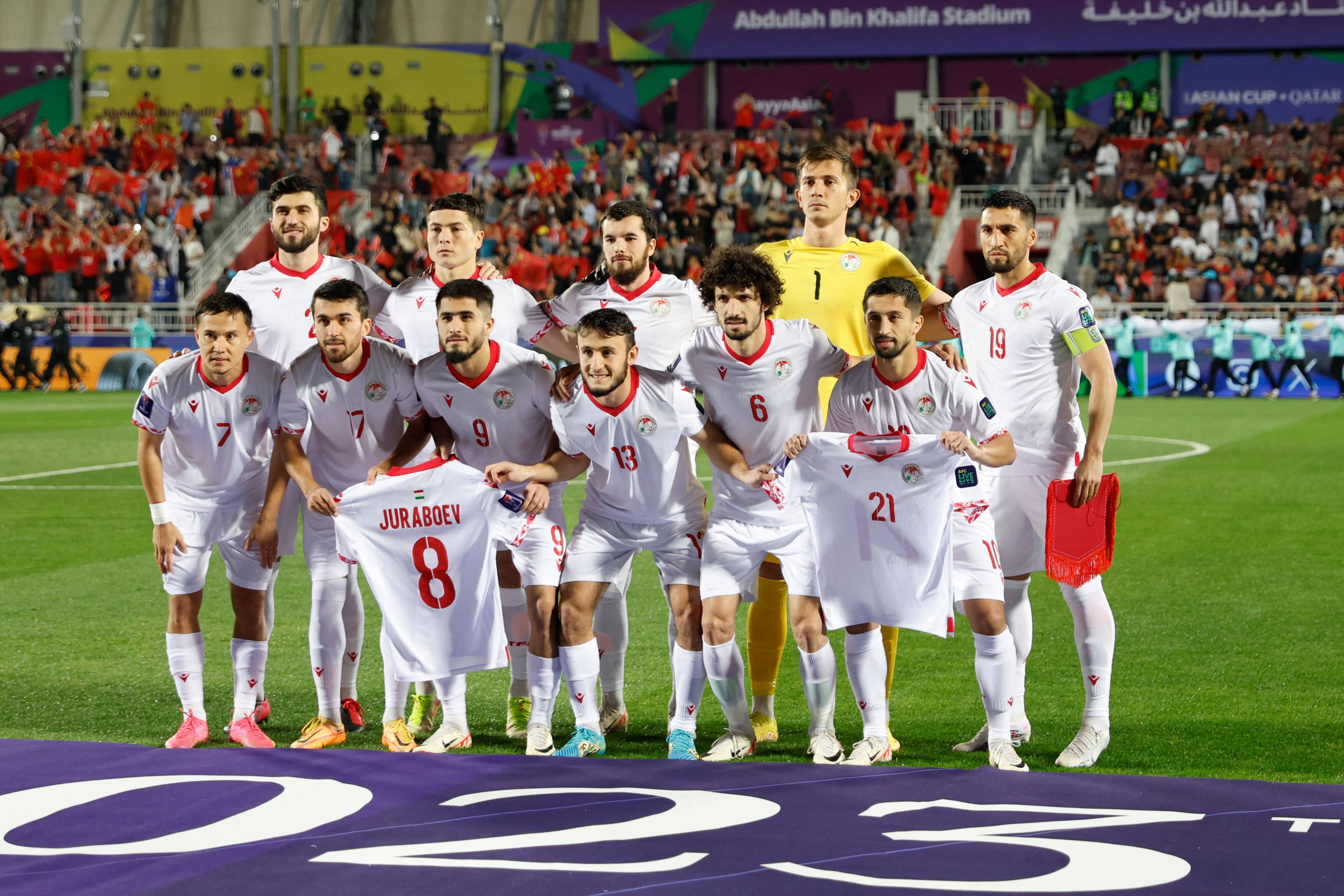 Tajikistan players displayed the shirts of Manuchekhr Dzhalilov and Amirbek Juraboev before their Asian Cup clash with China. Photo: AFP