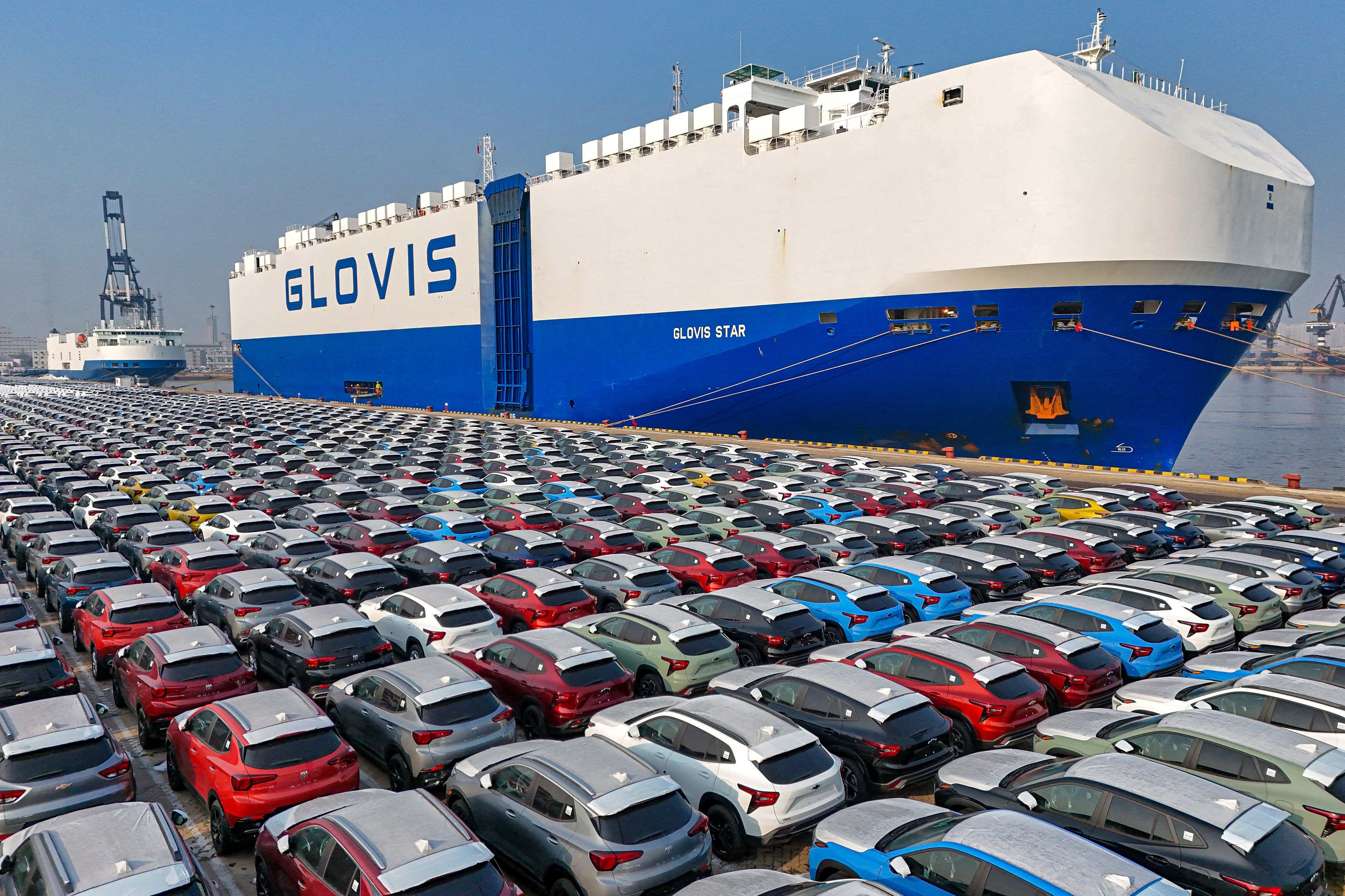Chinese cars await loading aboard a cargo ship at the port in Yantai, Shandong province on January 2, 2024. Photo: AFP