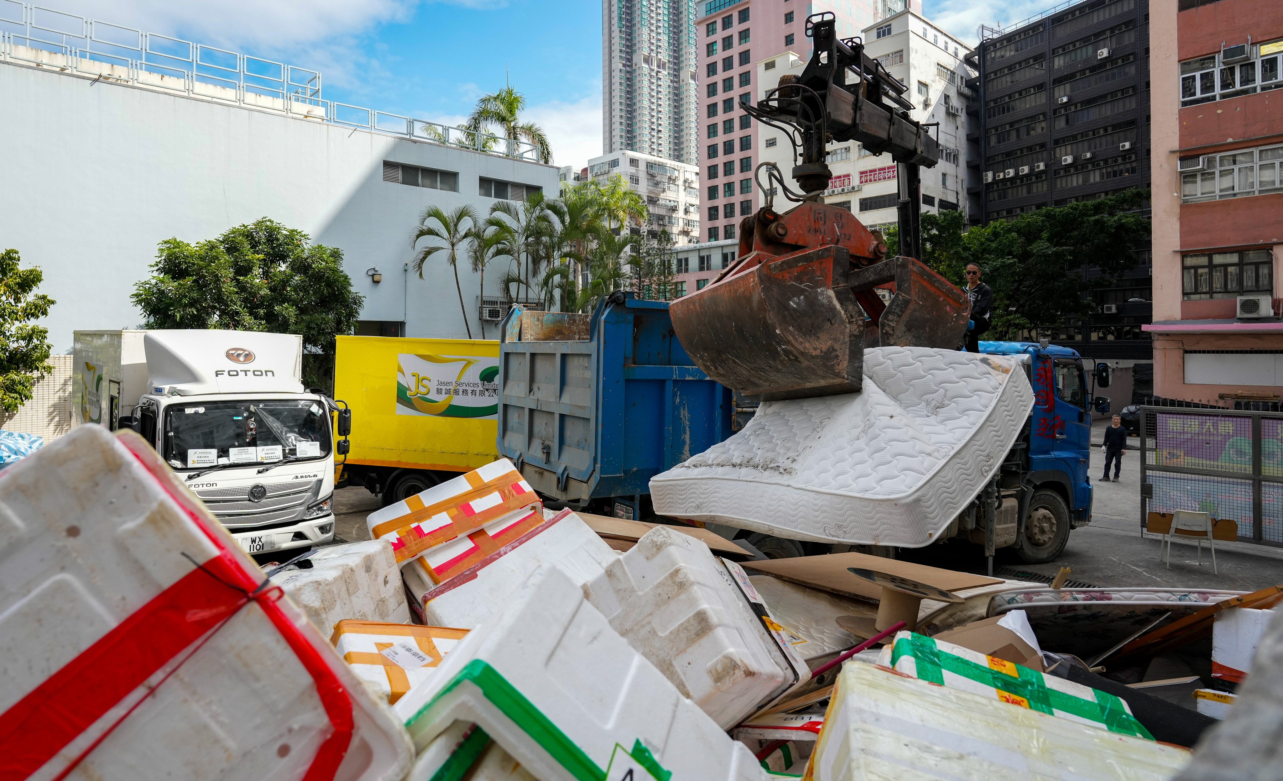 A garbage truck collect household waste and furniture in Cheung Ning Street Refuse Collection Point. The coming waste-charging scheme may put care homes under financial pressure. Photo: Eugene Lee