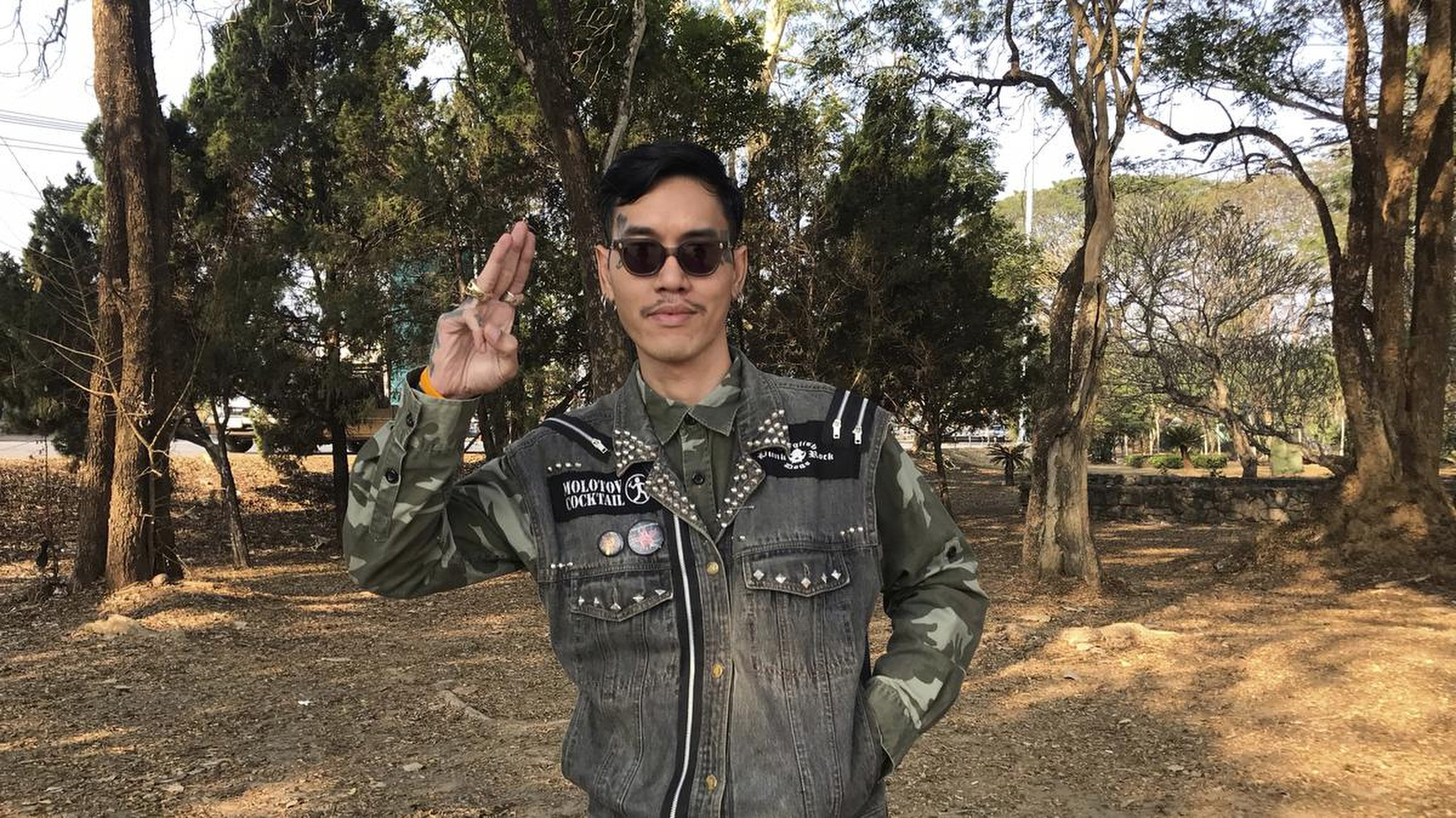 Thai political activist Mongkhon Thirakot flashes the pro-democracy gesture of a three-finger salute. He was given a 50-year jail sentence for insulting the monarchy, on Thursday. Photo: SCMPOST