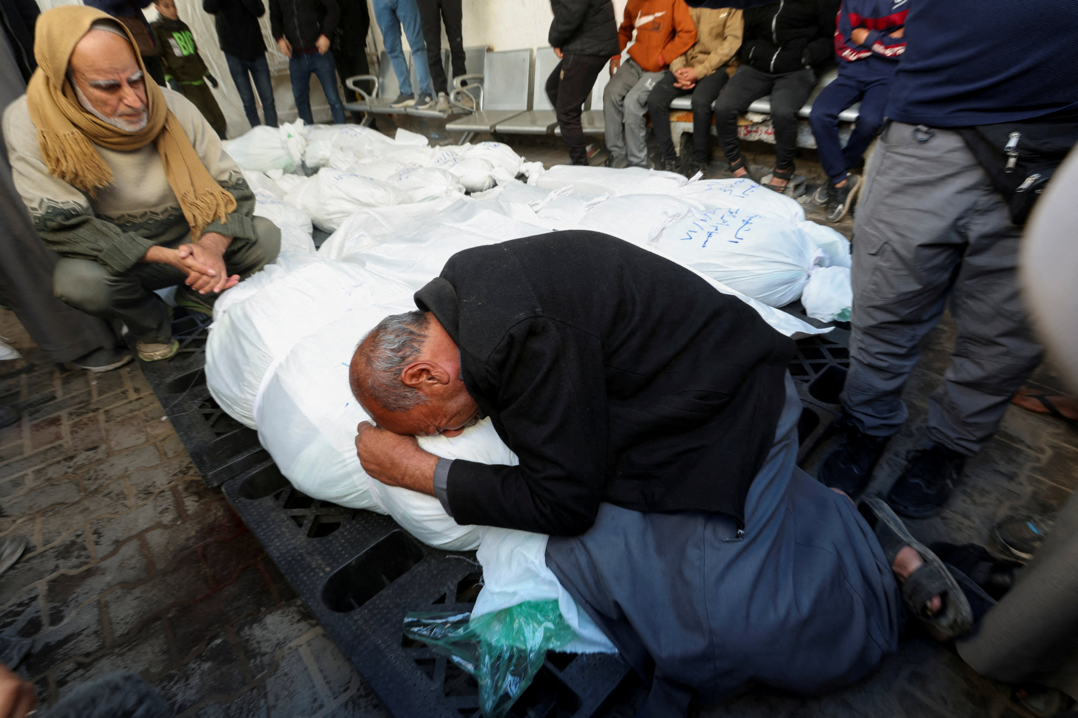 People mourn next to bodies of Palestinians killed in an Israeli strike, in Rafah in the southern Gaza Strip. Photo: Reuters