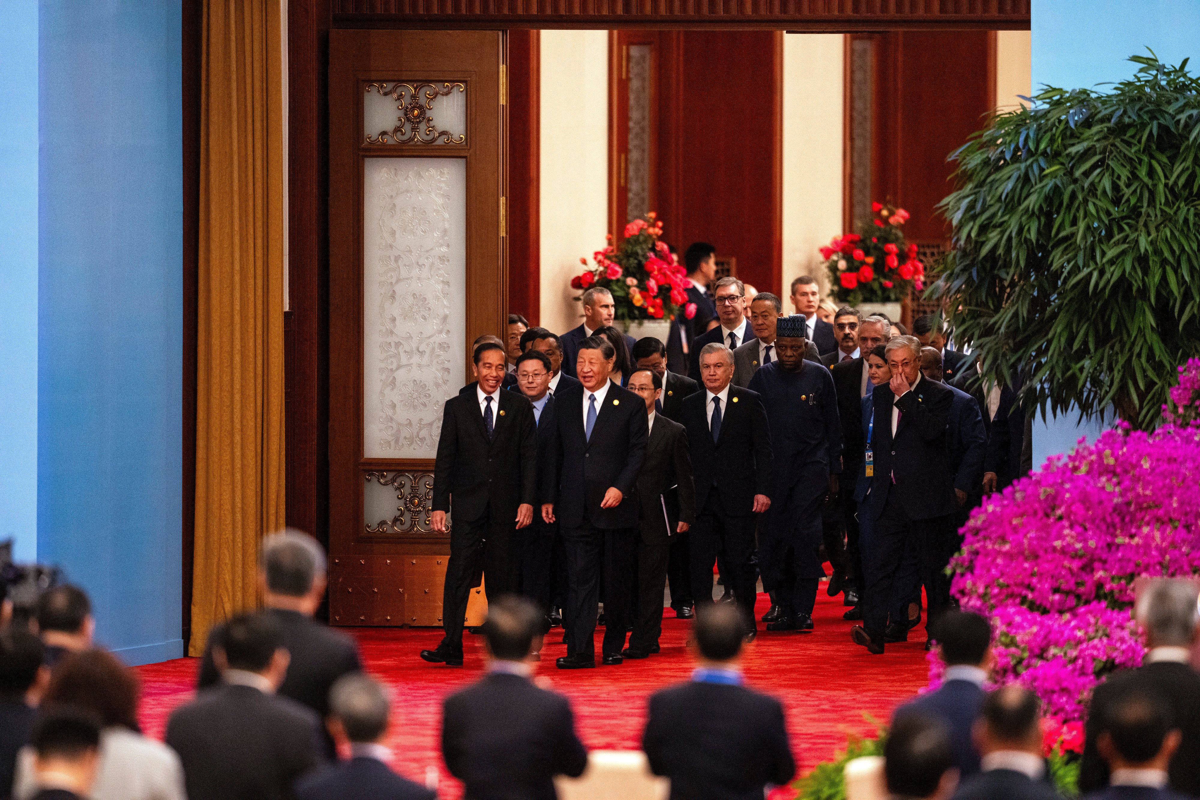 Chinese President Xi Jinping (third form left) chats with Indonesian President Joko Widodo (left) as they and other leaders arrive at the opening ceremony of the Belt and Road Forum at the Great Hall of the People in Beijing on October 18 last year. Photo: AP 