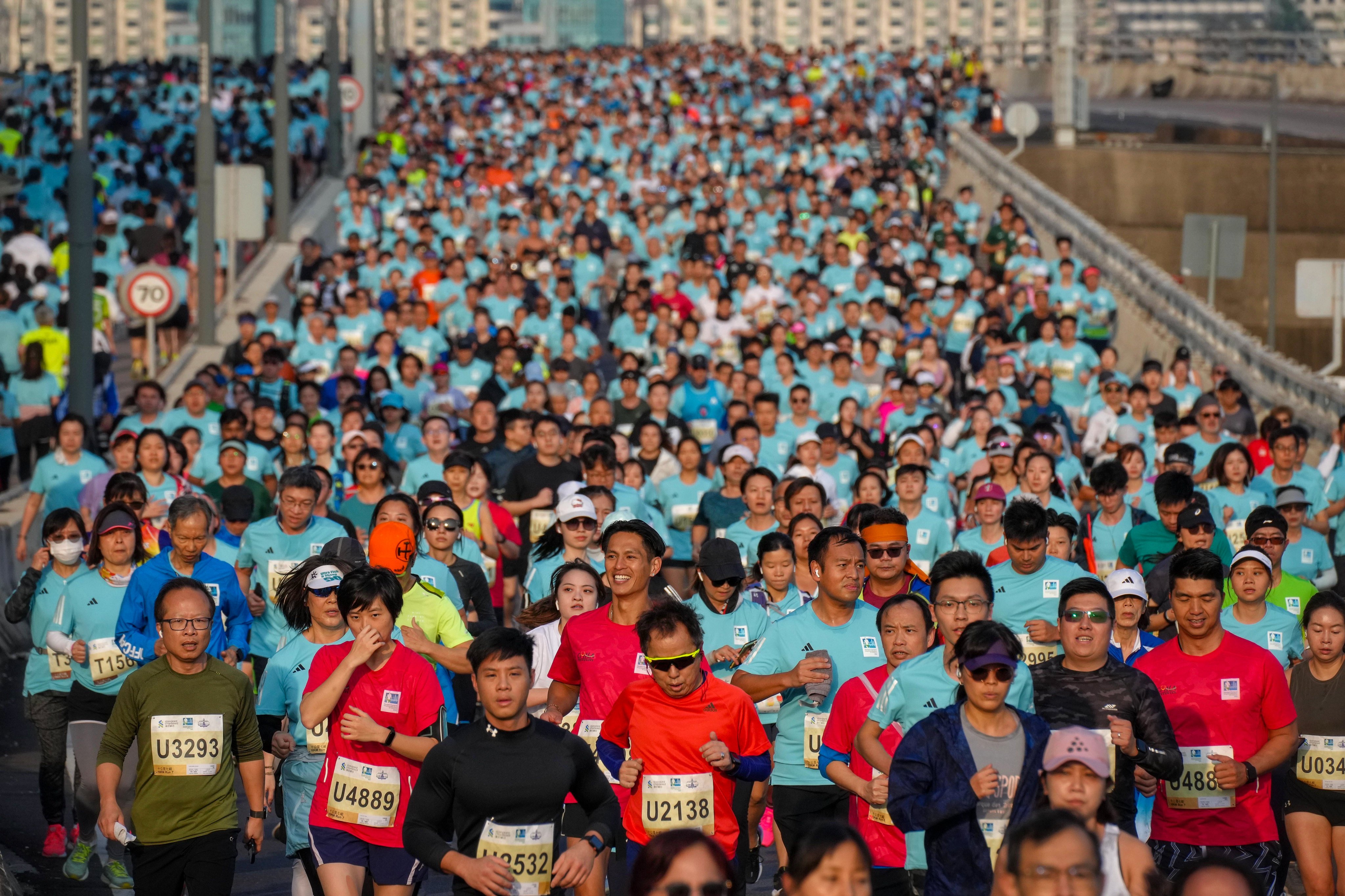 Runners take part in the the Standard Chartered Hong Kong Marathon, which marked a return to its full pre-pandemic quota of 74,000. Photo: Elson Li