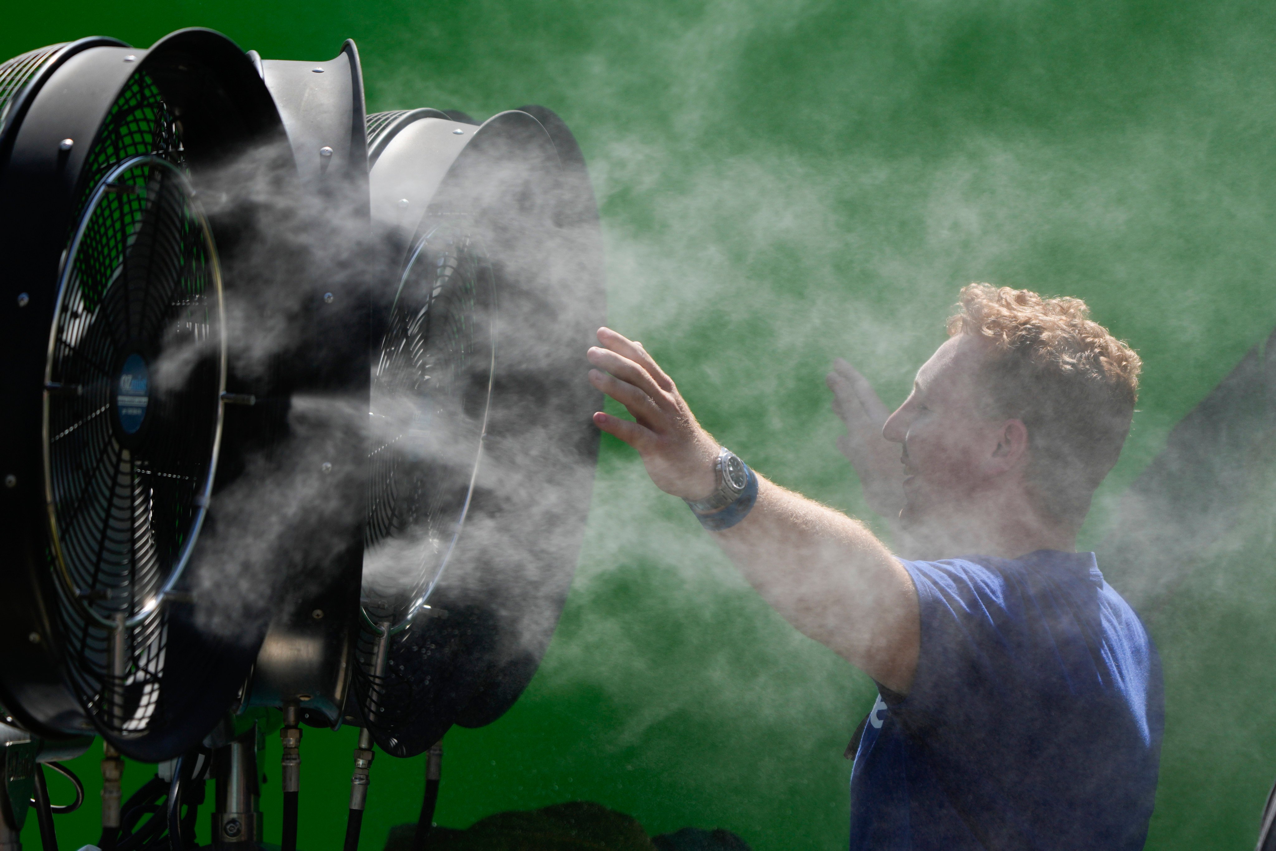 A spectator cools down during a practice day at the Australian Open in Melbourne. Parts of Australia are at “extreme” or “severe” levels of danger in the heatwave. Photo: AP