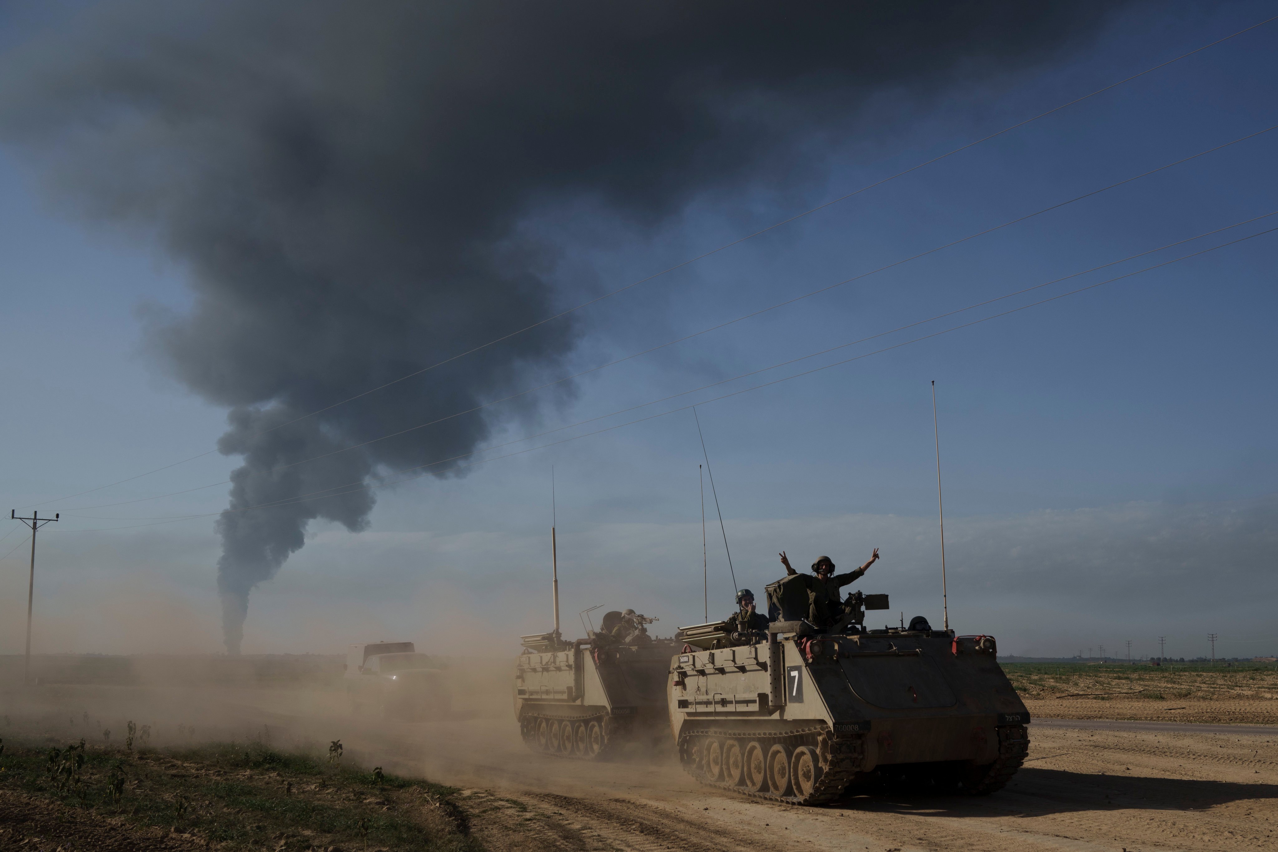 Israeli soldiers move on armoured personnel carriers near the Israeli-Gaza border. Photo: AP