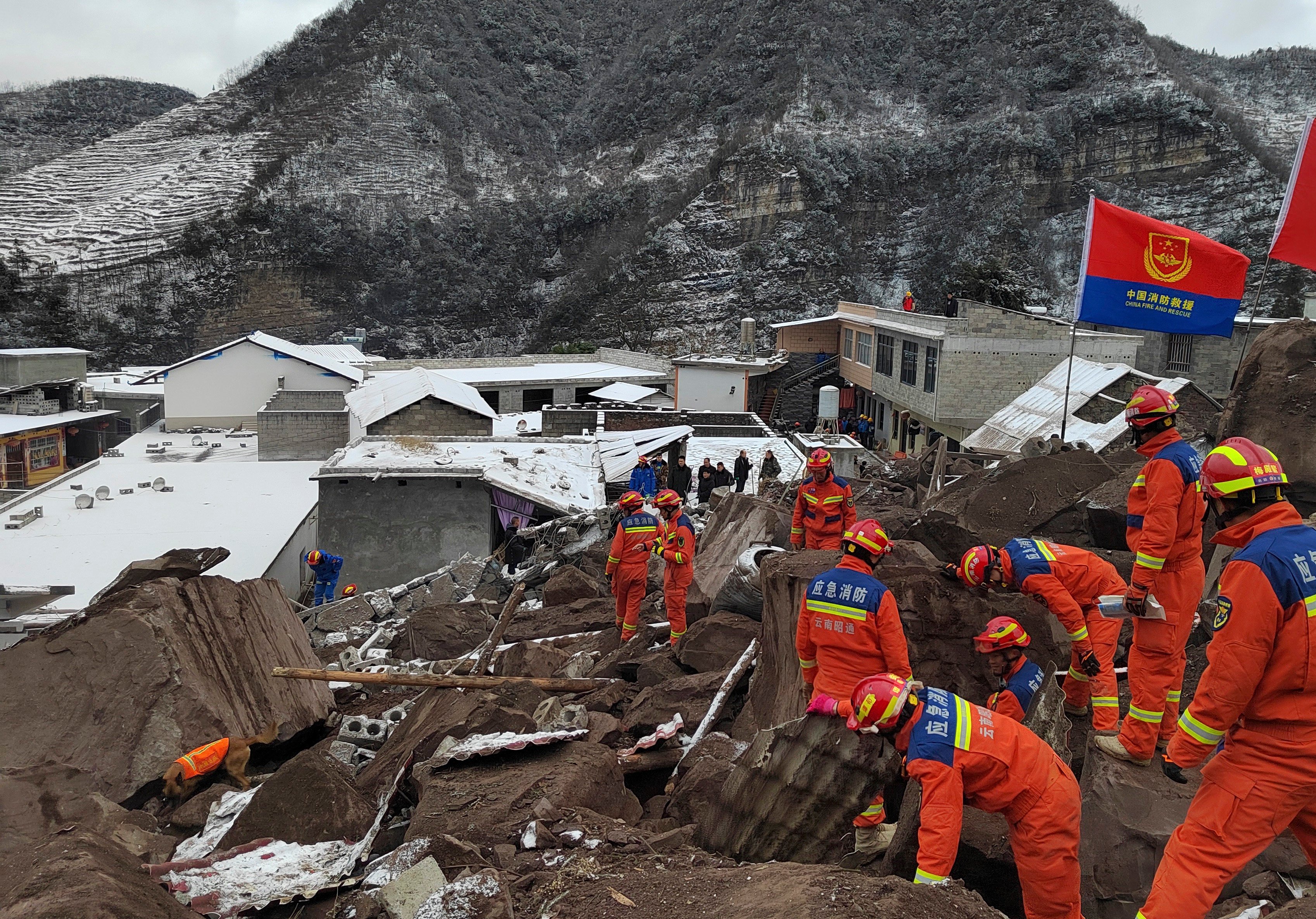 Rescuers look for victims of a landslide that struck the village of Liangshui in southwest Yunnan province on Monday. Photo: Xinhua