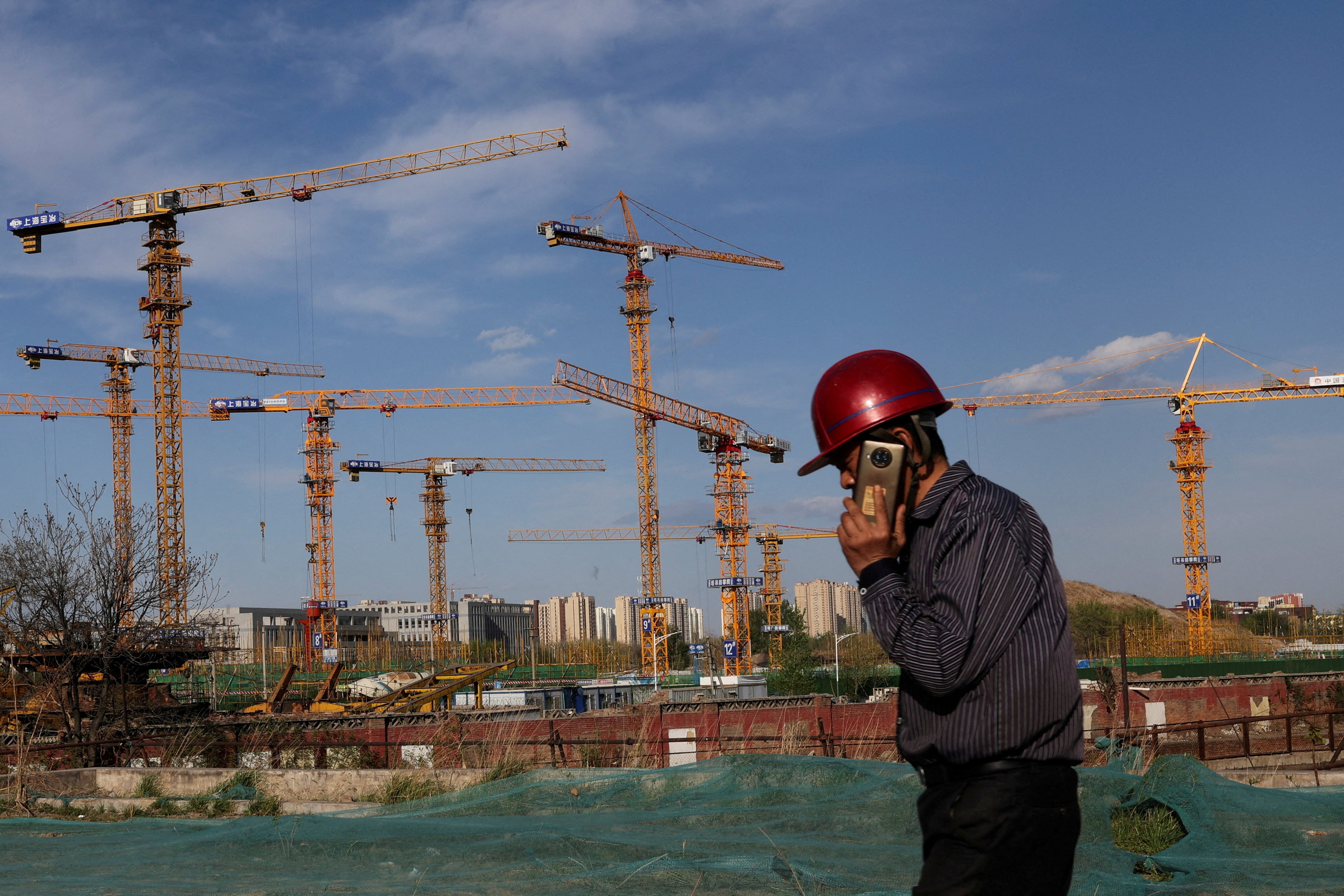 A worker walks past a construction site in Beijing in April 2022. The loss of confidence in the presales model following the eruption of the liquidity crisis in China’s housing market has provided fresh impetus for the rental market. Photo: Reuters