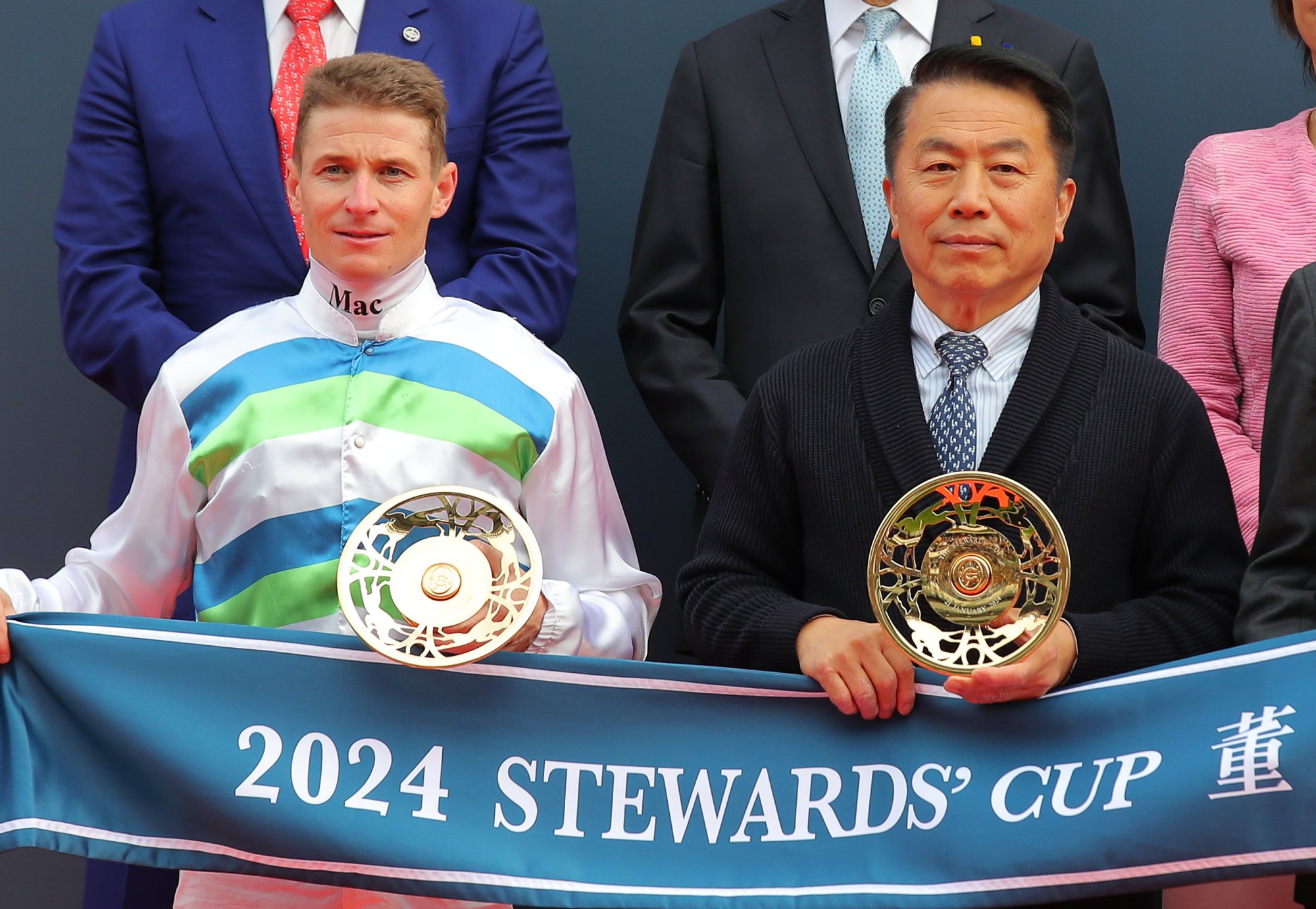 Jockey James McDonald and trainer Ricky Yiu collect their Stewards’ Cup silverware.