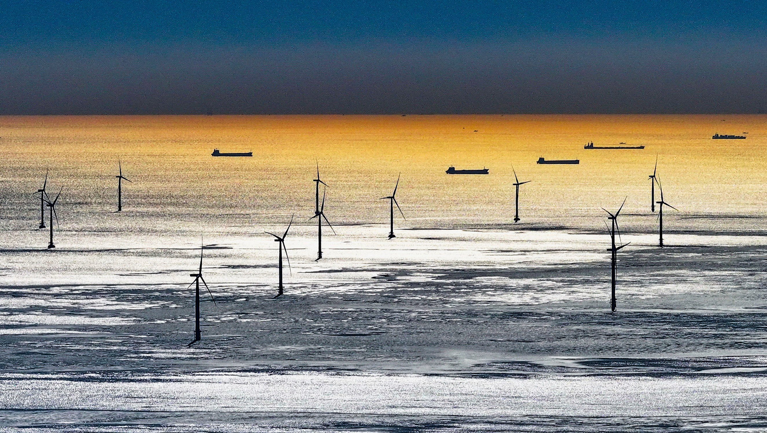 (231223) -- TANGSHAN, Dec. 23, 2023 (Xinhua) -- This aerial photo taken on Dec. 22, 2023 shows an offshore wind farm in Tangshan City, north China’s Hebei Province. In recent years, Tangshan City in Hebei Province encouraged the development of clean energy and promoted the construction of wind and solar power plants. By far, the installed capacity of clean energy in Tangshan reached 3.242 million kilowatts. (Xinhua/Yang Shiyao)