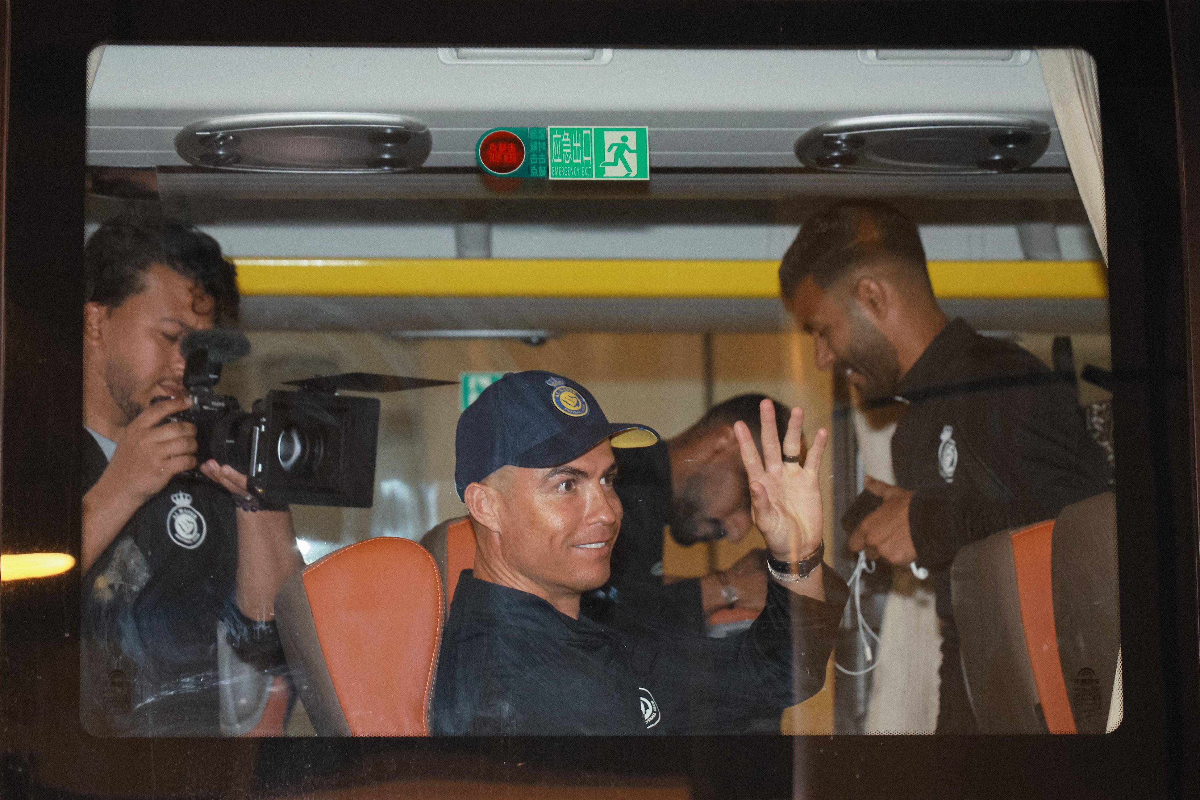 Cristiano Ronaldo waves to fans from a bus on arrival in Shenzhen on Sunday. Photo: EPA-EFE