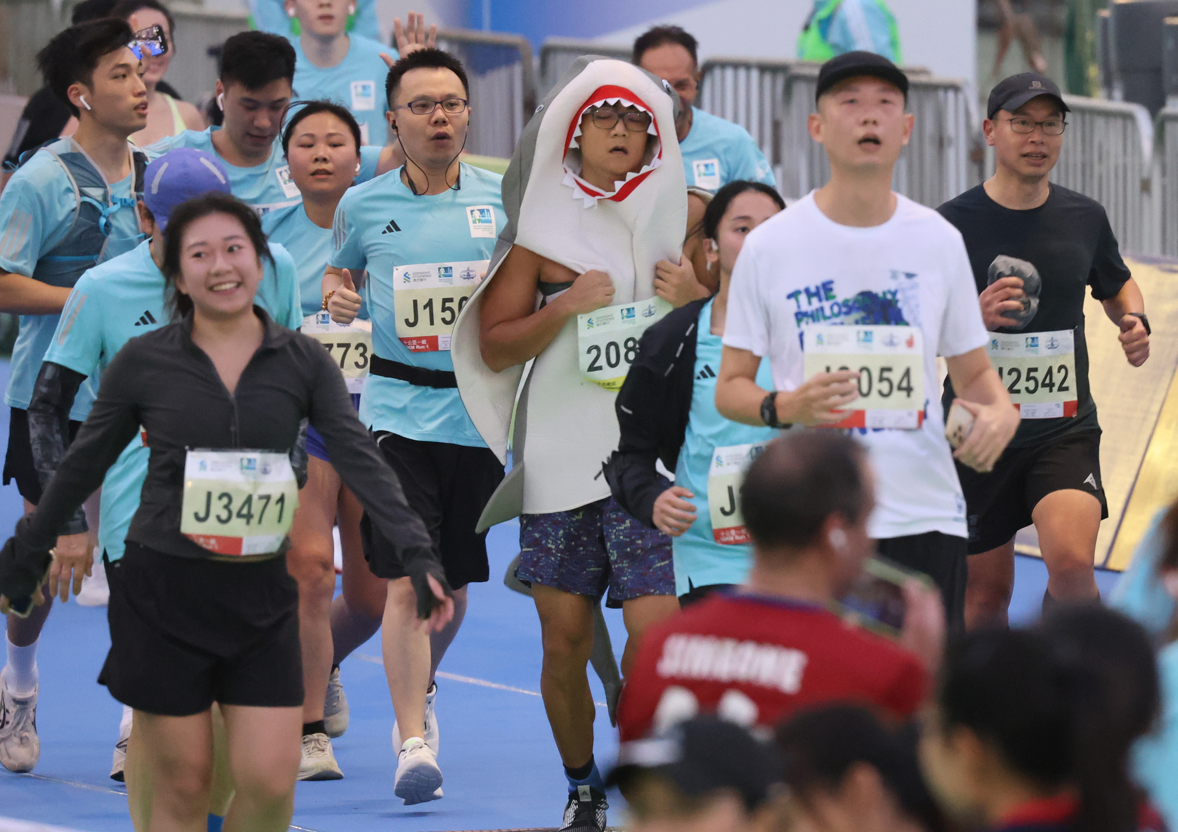 Runners arrive at the finish line of the Standard Chartered Hong Kong Marathon on Sunday. Photo: May Tse