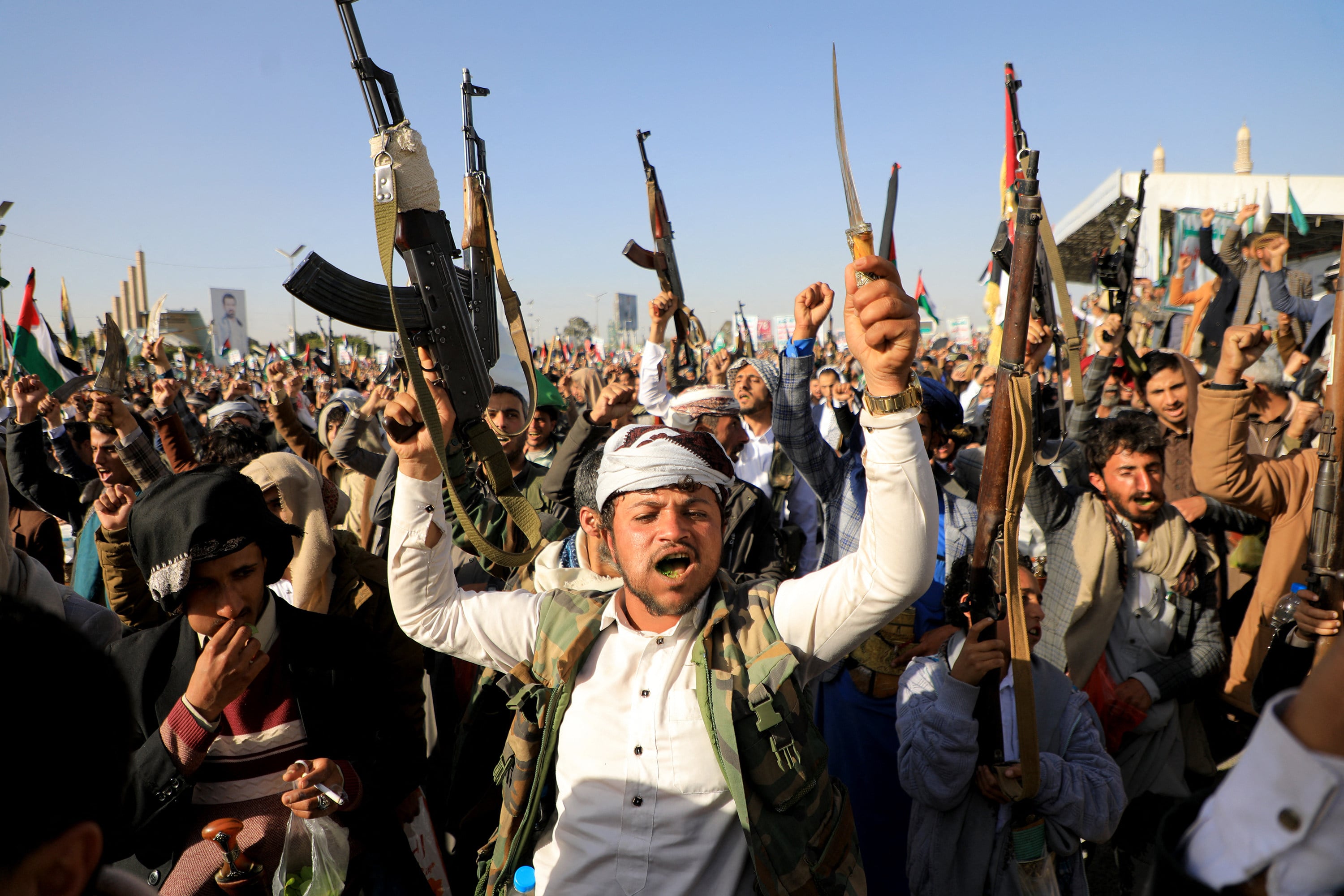 Houthi fighters brandish their weapons in the Houthi-controlled Sanaa, capital of Yemen on January 12 following US and British forces strikes. Photo: TNS