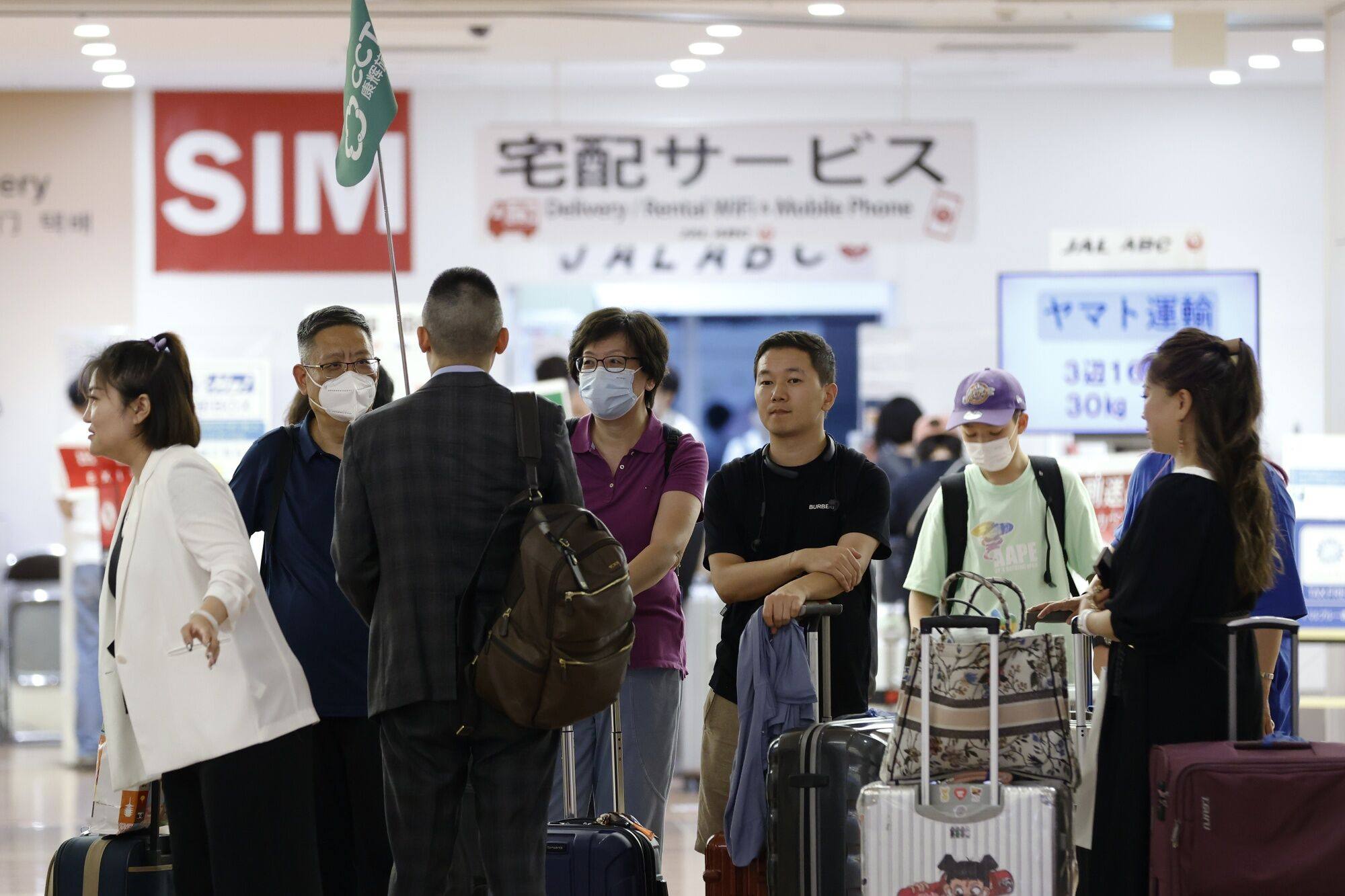 Chinese tourists arrive at Haneda Airport. Survey respondents that spoke to This Week in Asia clarified they did not dislike the Chinese people and culture, with their negative feelings only aimed at the Chinese government. Photo: Bloomberg