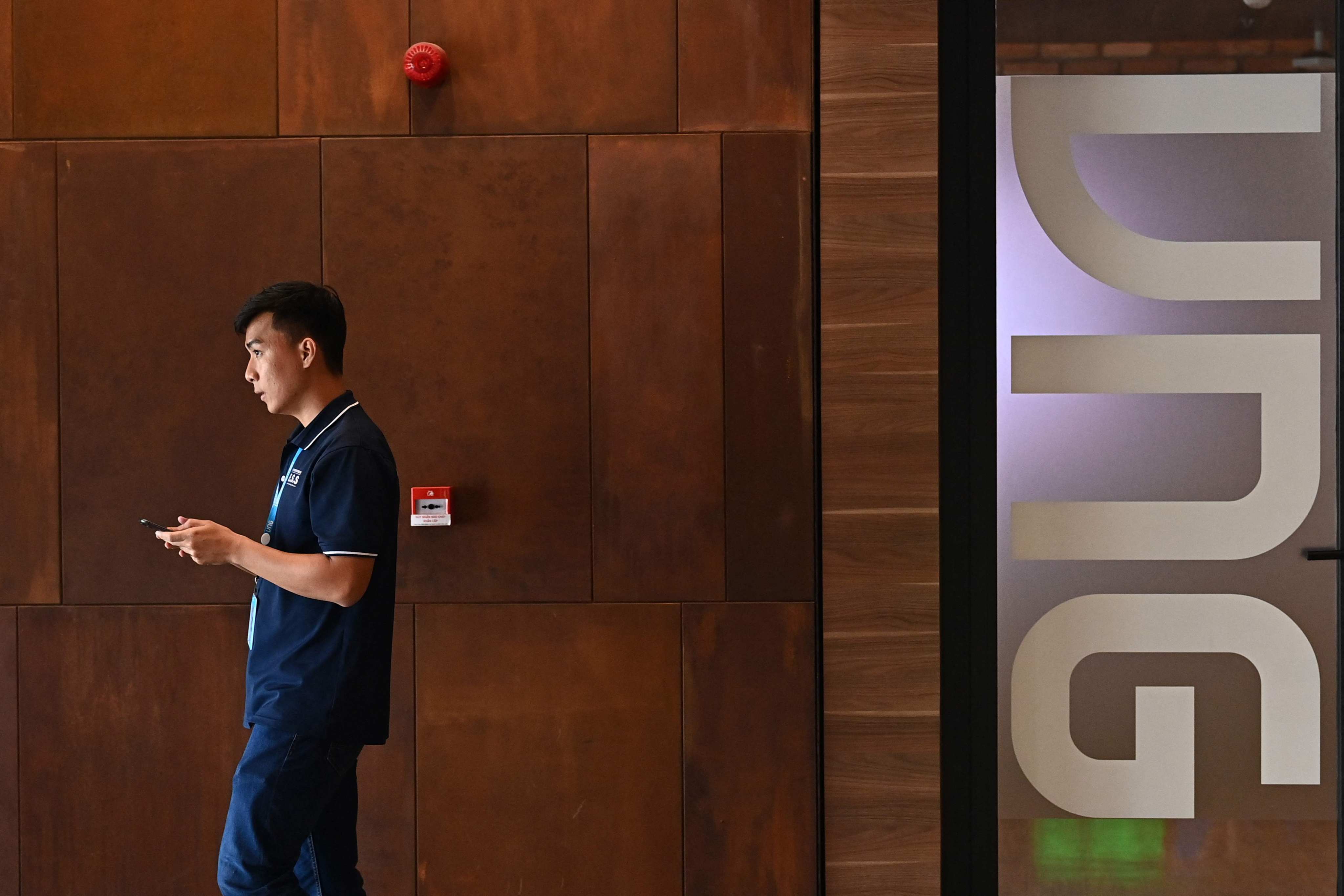 A staff member using a mobile phone at the headquarters of Vietnamese internet firm VNG in Ho Chi Minh City. Photo: AFP