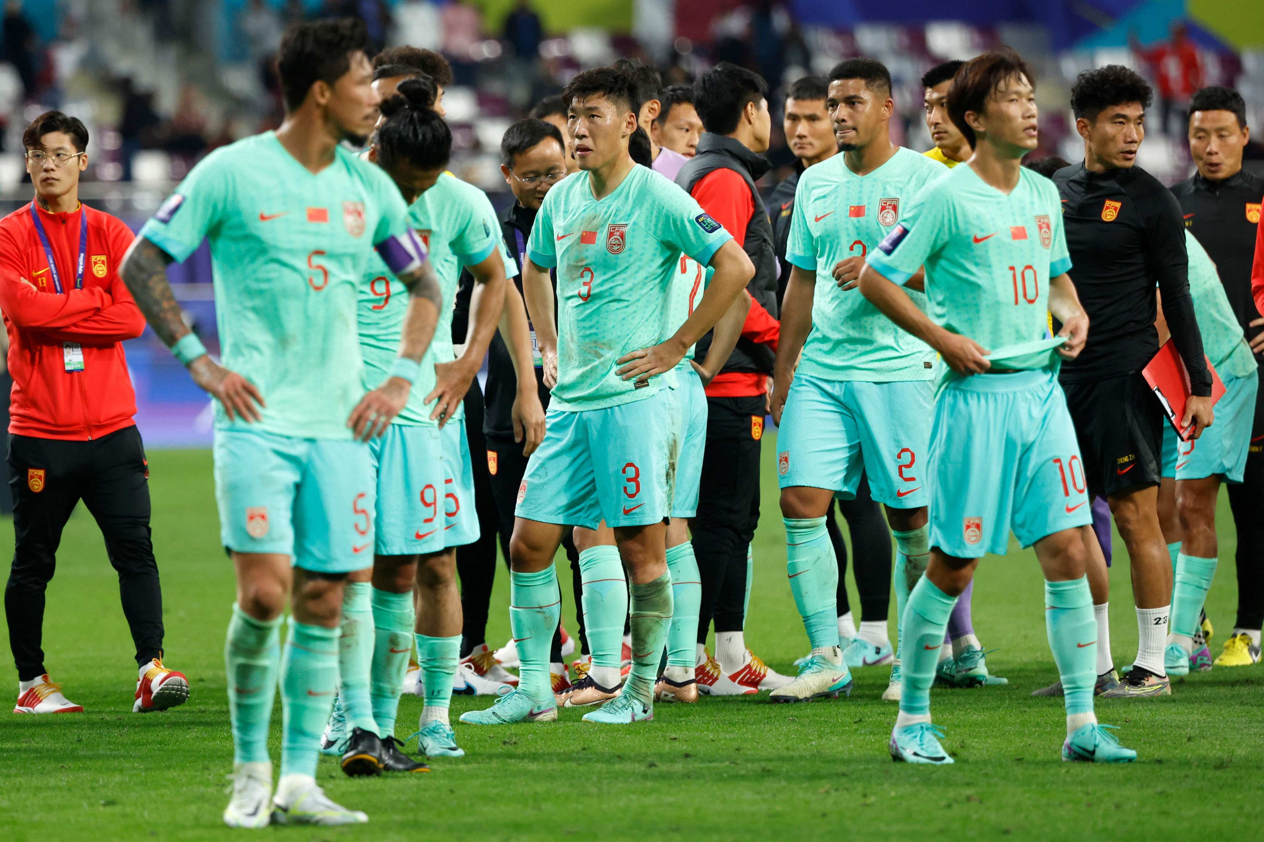 China’s crestfallen players process the likely consequence of failing to score for a third straight match in Qatar. Photo: AFP