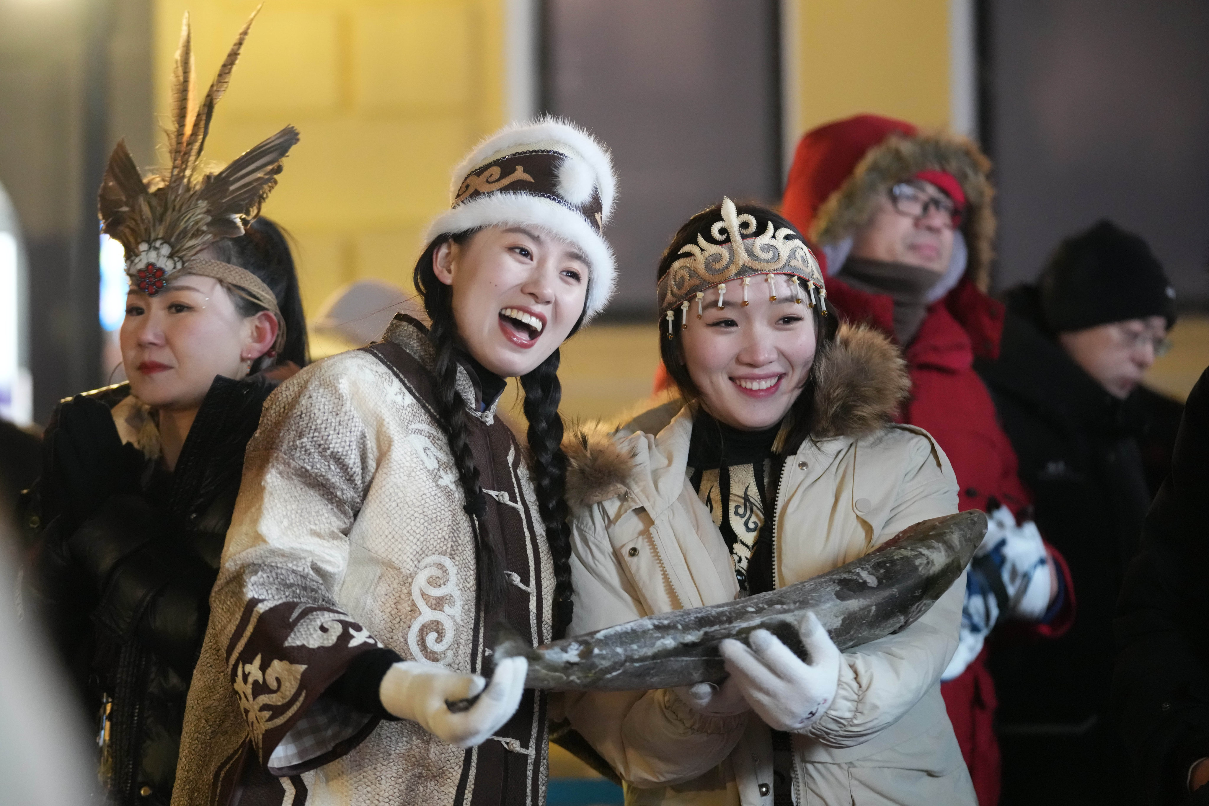 People wear traditional clothing of the Hezhe ethnic group of northeast China at an event in Heilongjiang province on January 6. Photo: Xinhua
