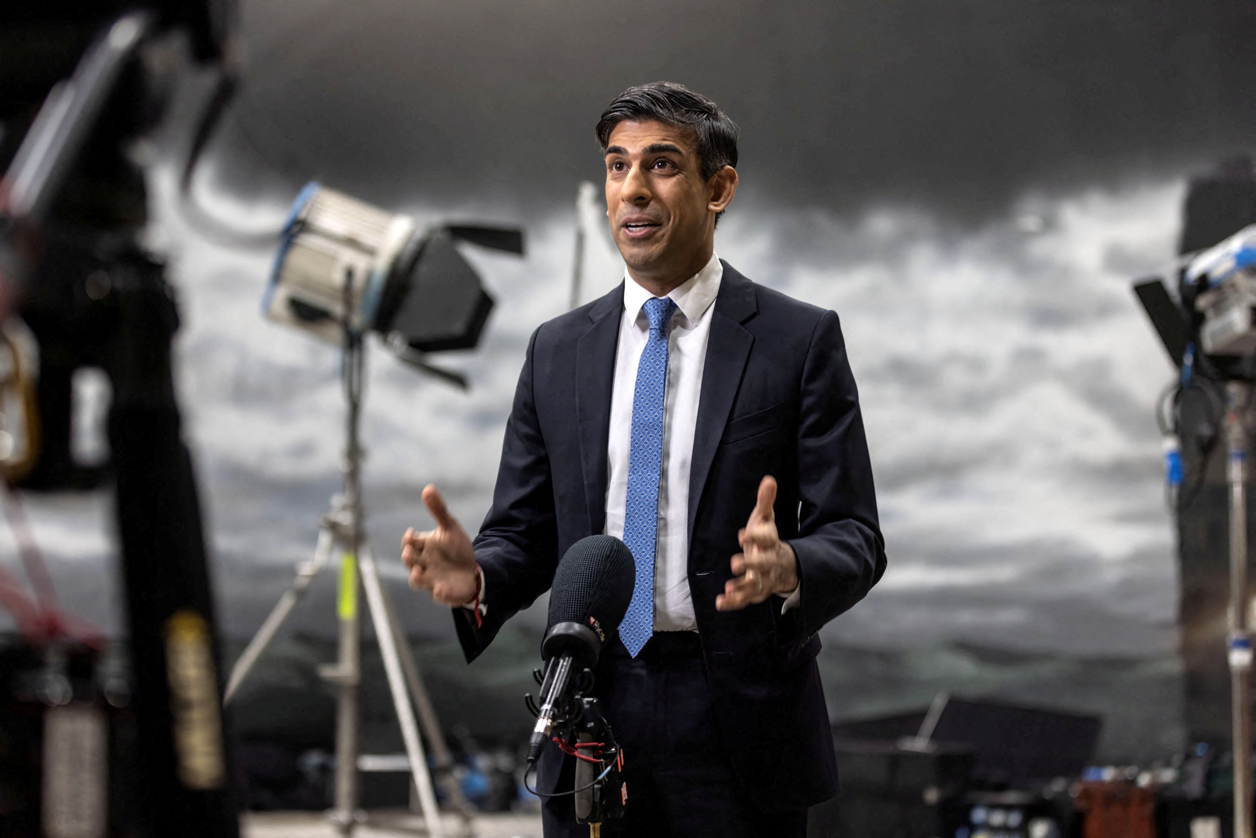 Britain’s Prime Minister Rishi Sunak gives a television interview in front of a painted backdrop of a stormy sky in Beaconsfield, Buckinghamshire, on Monday. Photo: Reuters