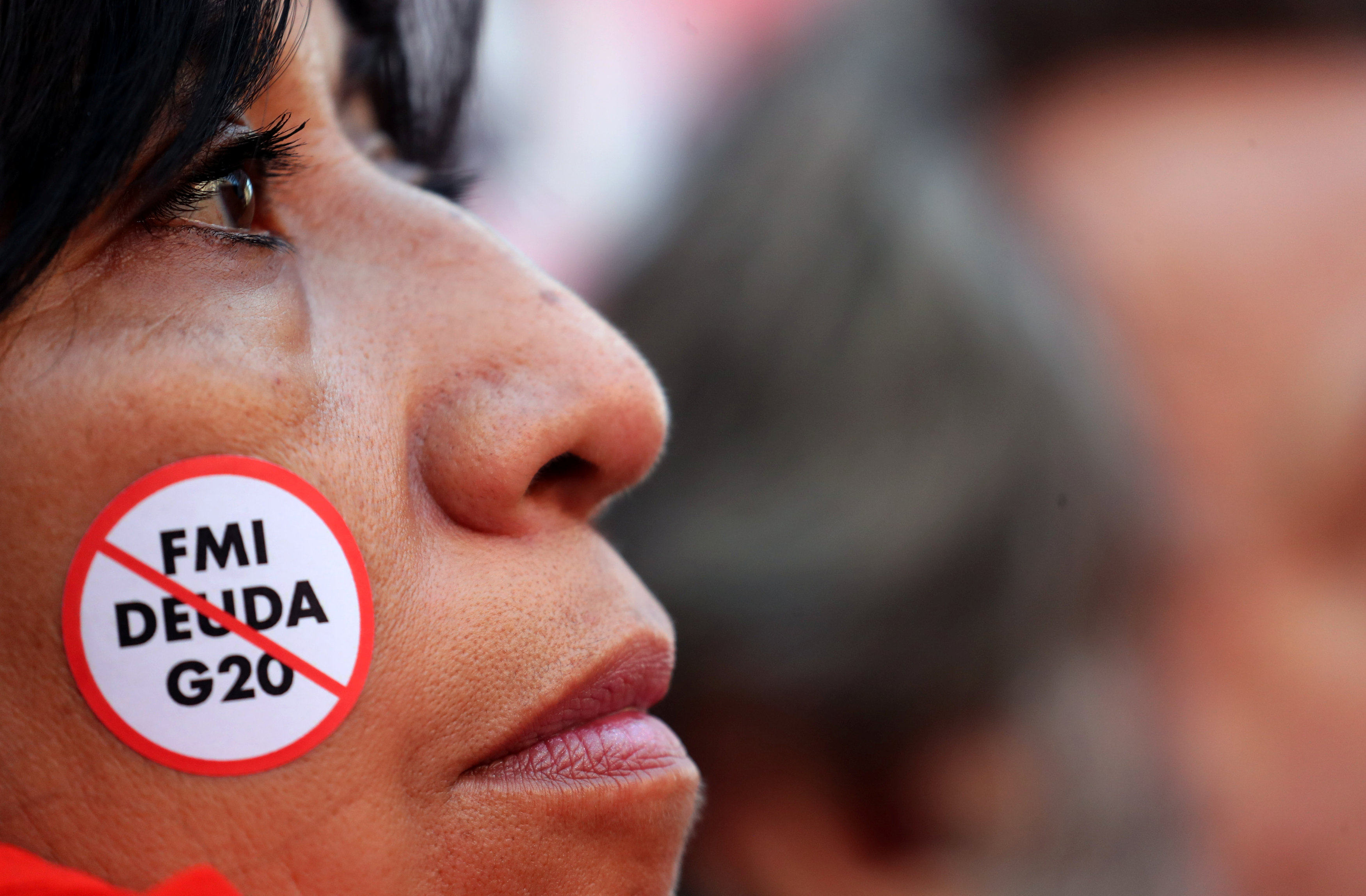 A demonstrator with an anti IMF debt and G20 sticker takes part in a protest against a G20 finance ministers’ meeting in Buenos Aires, Argentina, in July 2018. Over the past three years, 18 sovereign defaults have occurred in 10 developing countries – more than the total over the past two decades. Photos: Reuters 