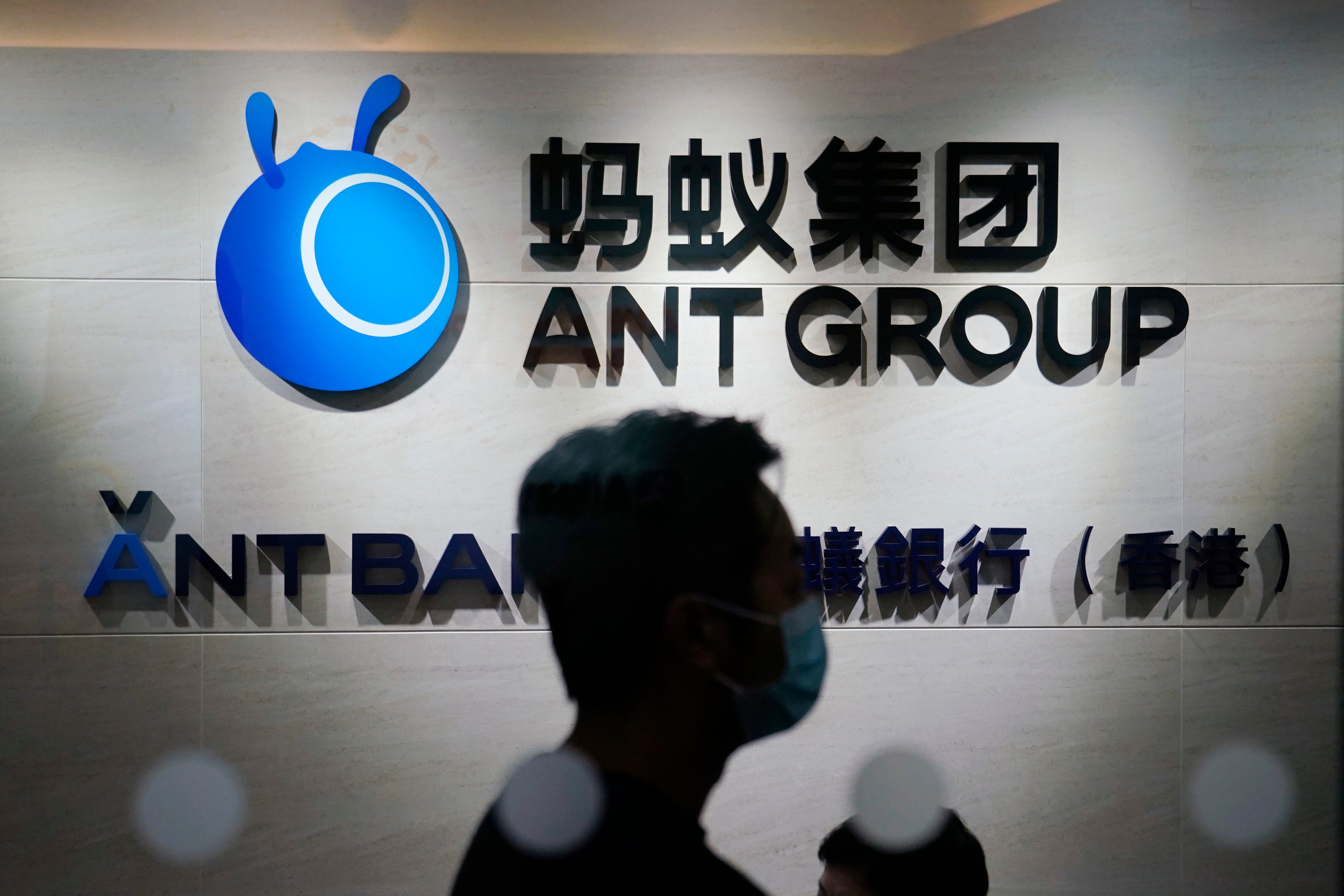 An employee passes a logo of Ant Group at its office in Hong Kong in a 2020 file photo. Photo: AP