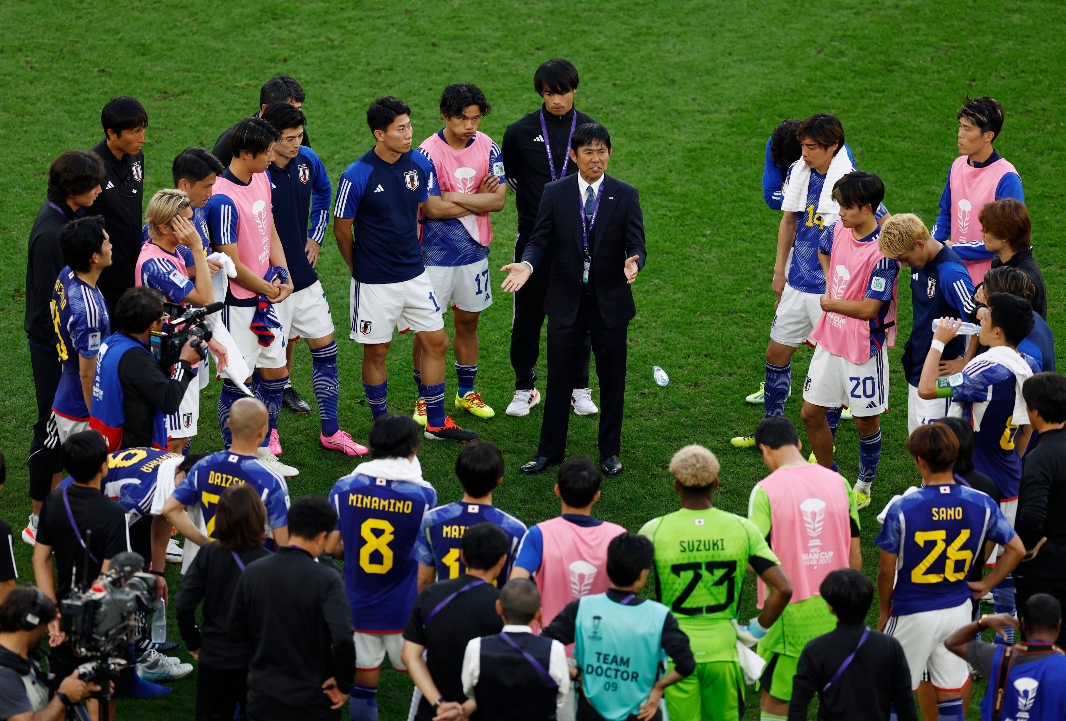 Japan head coach Hajime Moriyasu talks to his players after their win over Indonesia. Photo: Reuters