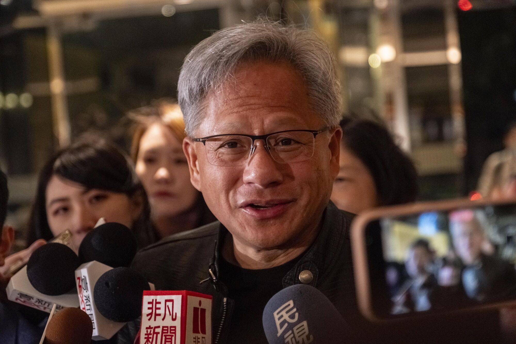 Jensen Huang, co-founder and CEO of Nvidia, arrived at an event in Taipei on Thursday, surrounded by media. Photo: Bloomberg