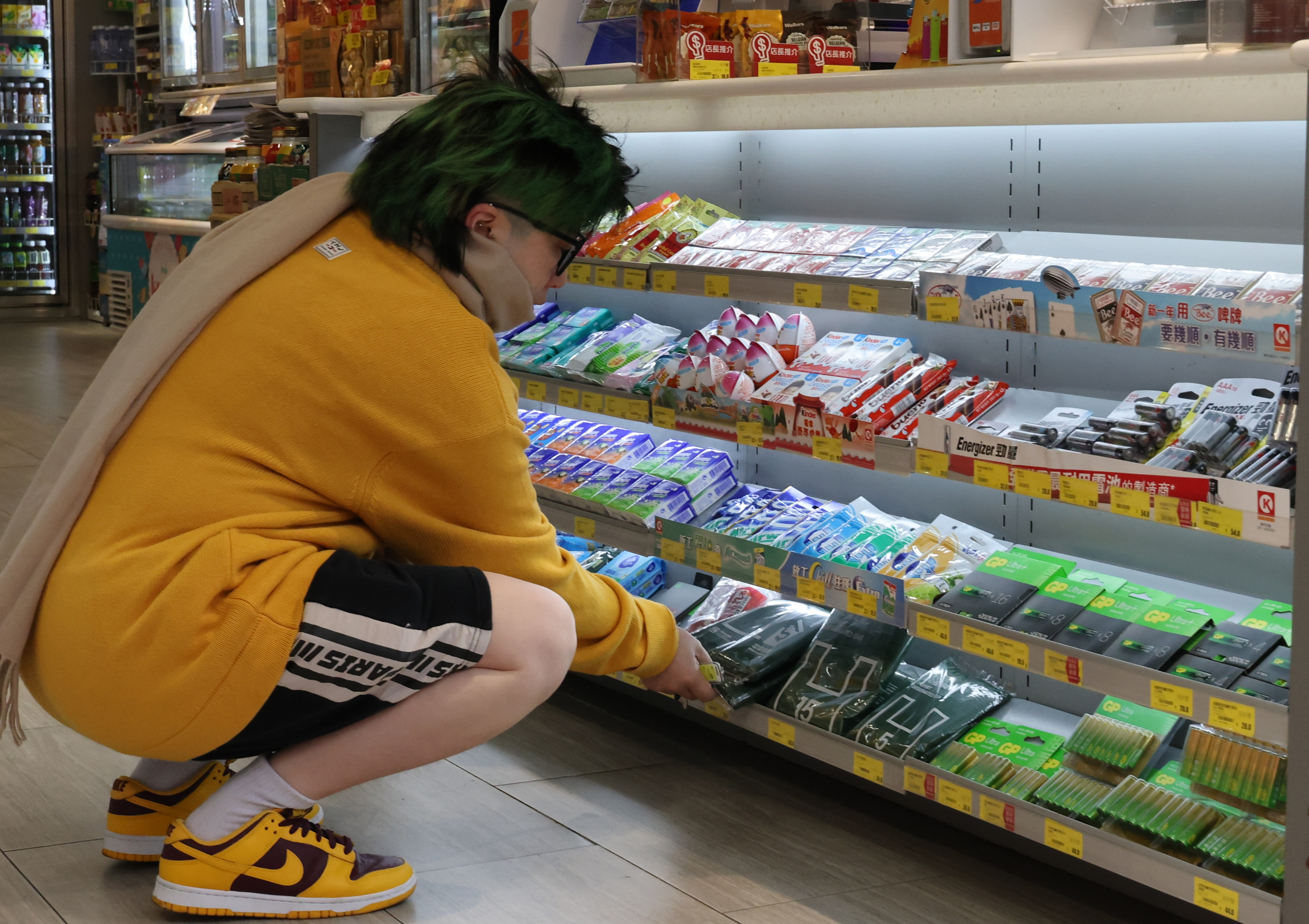 A woman buys a designated rubbish bag at a convenience store in Mong Kok. Photo: Jelly Tse