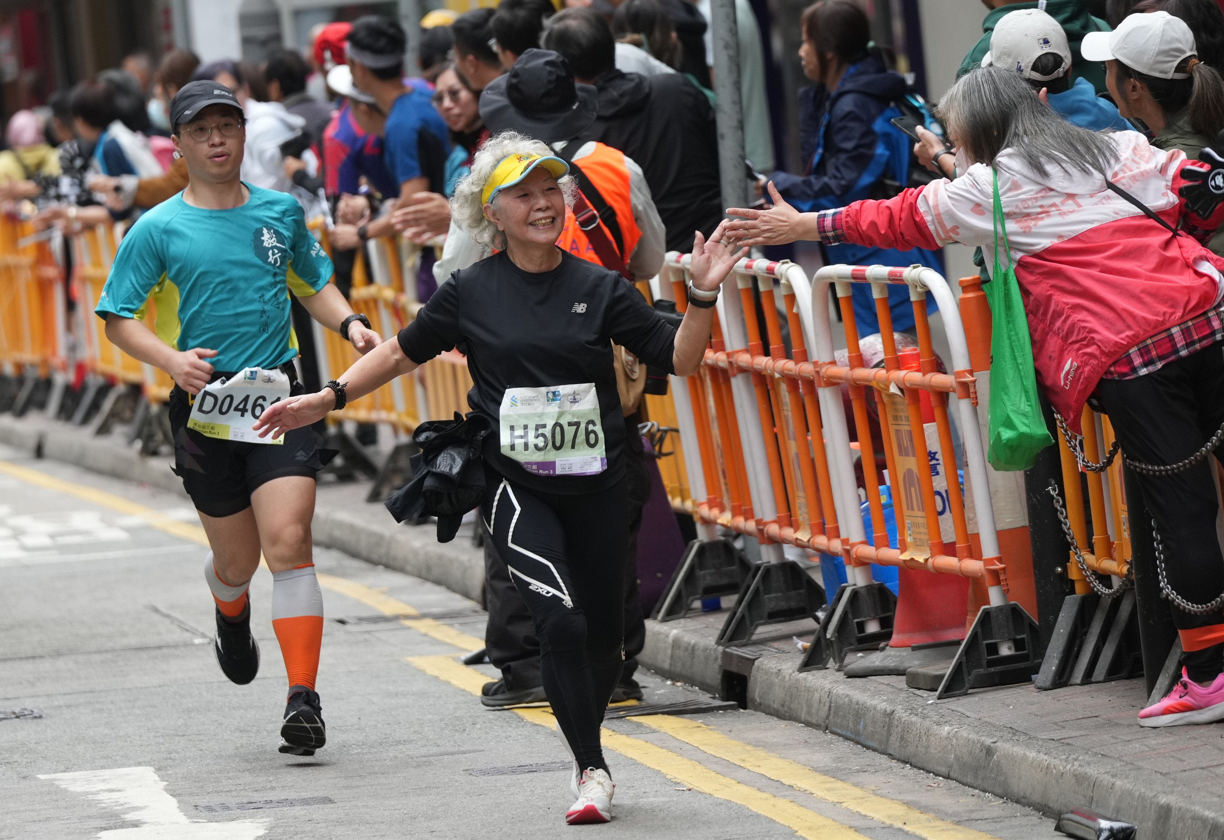Runners enjoy the crowds in Causeway Bay during the Hong Kong Marathon event on January 21. Photo: Eugene Lee