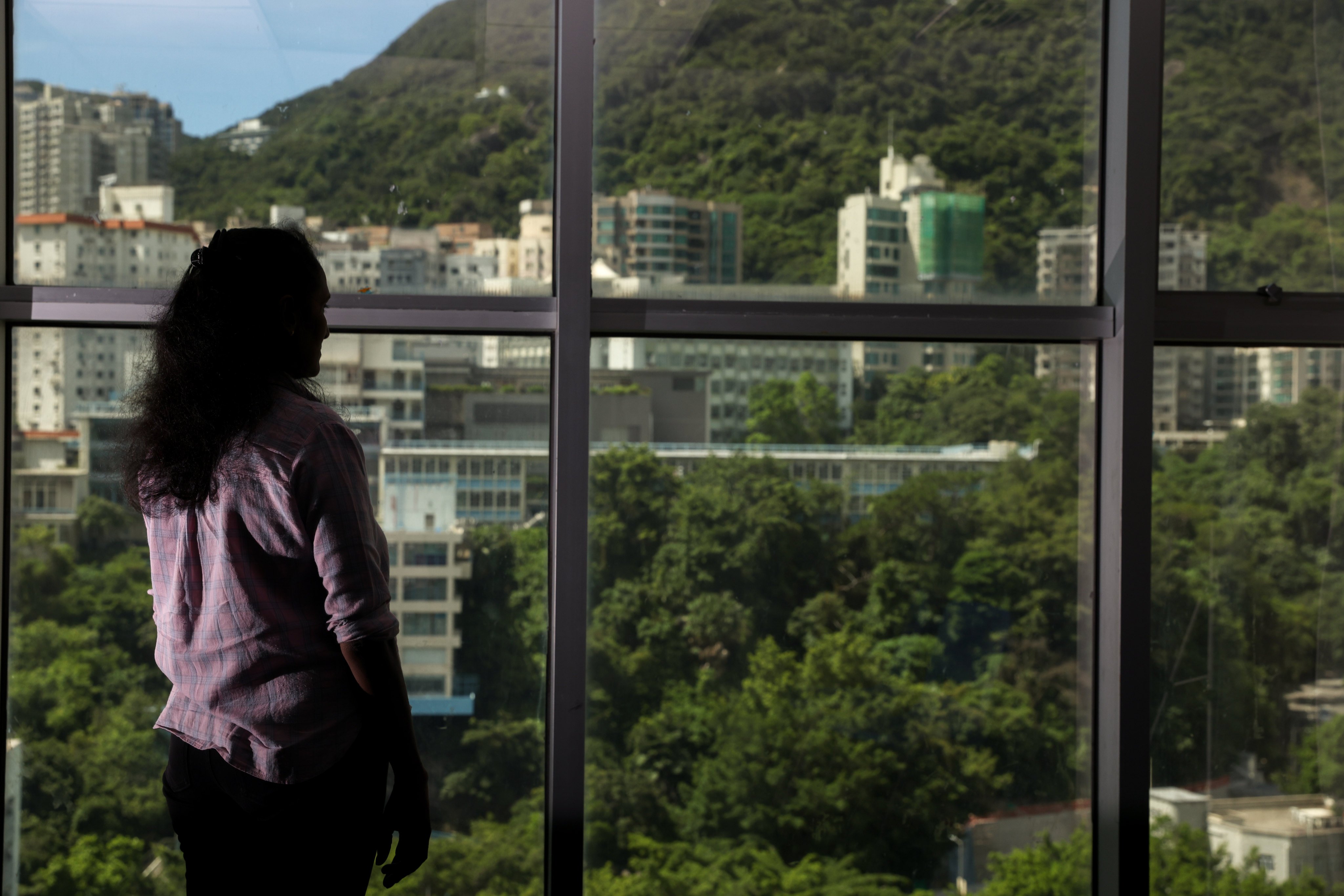 Gita, a Sri Lankan national, looks out over Hong Kong. She claims to have been the victim of abuse at the hands of her former employer in the city. Photo: Yik Yeung-man