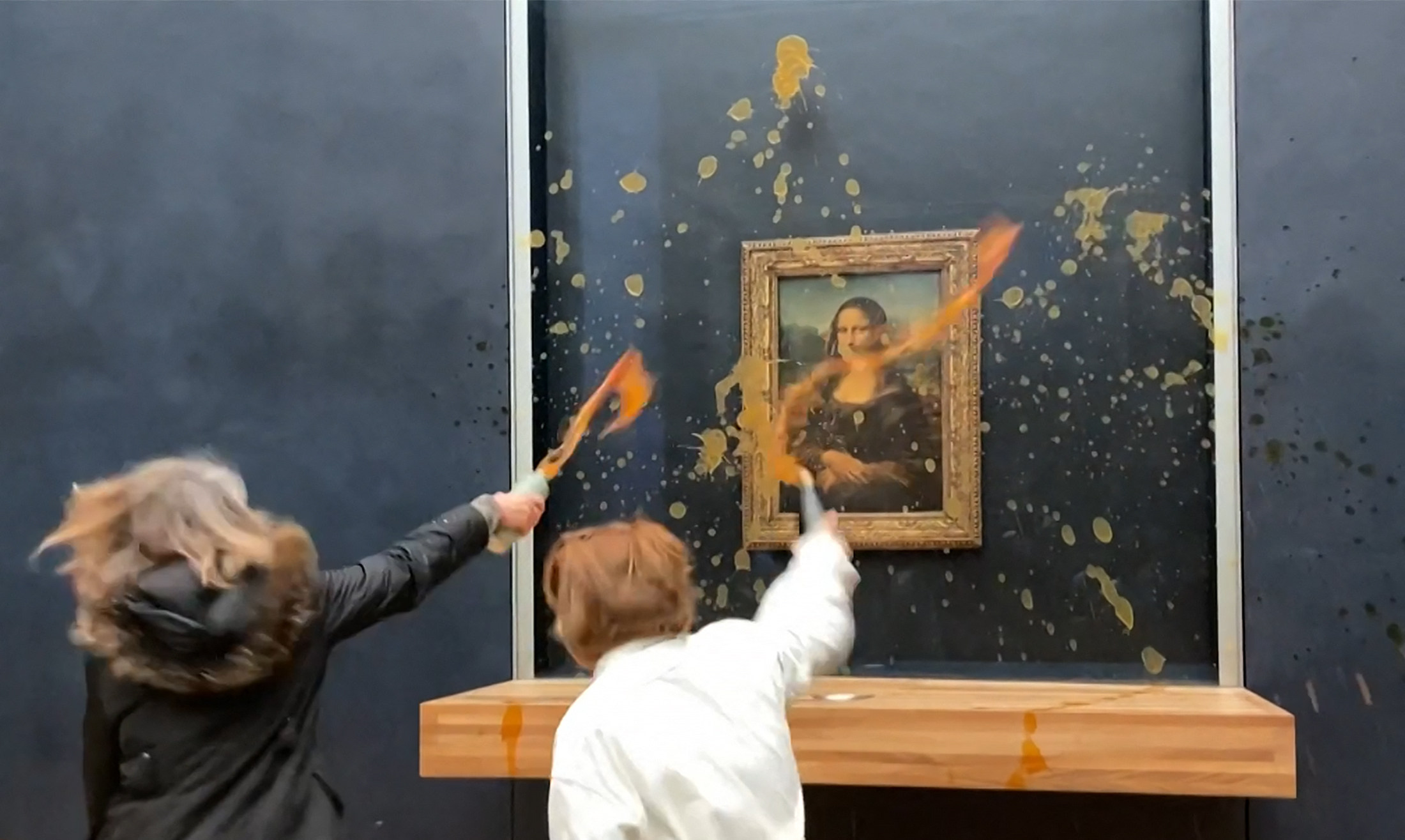 Environmental activists take aim at Leonardo Da Vinci’s famous Mona Lisa painting in Paris on Sunday. Photo: AFP