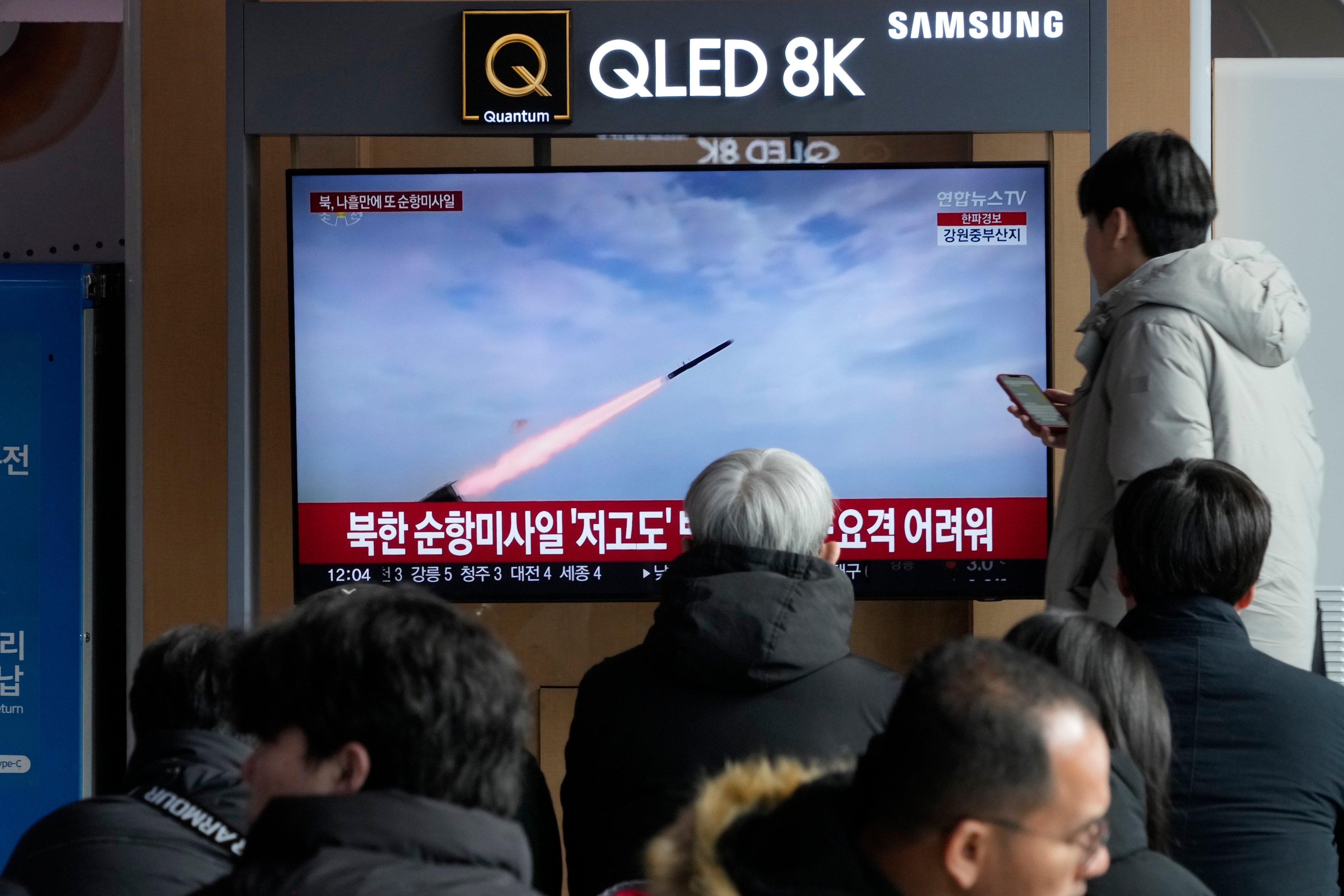 People watch a news broadcast pertaining to a North Korean missile launch, at the Seoul Railway Station in Seoul, South Korea, on Sunday. Photo: AP