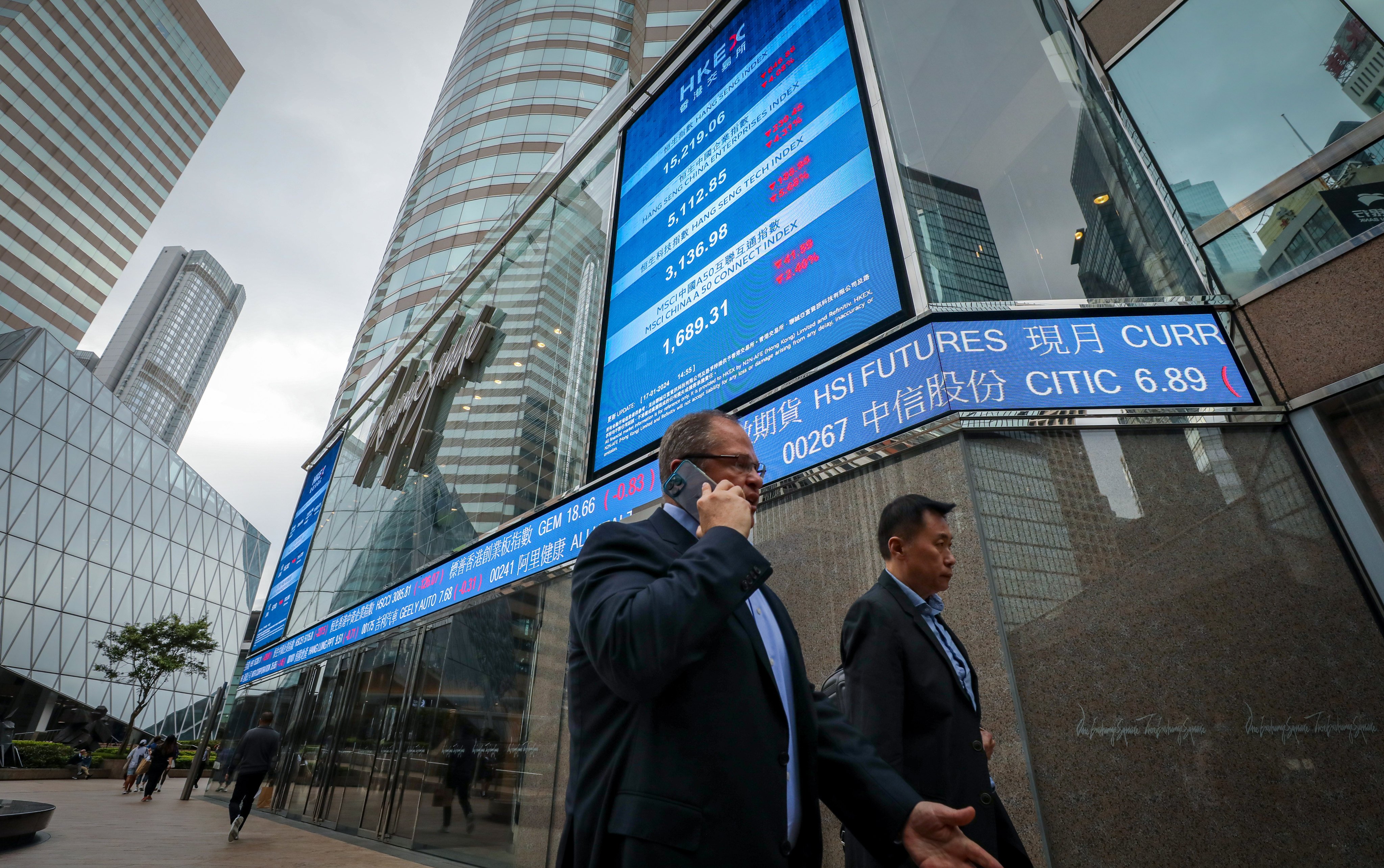 People walk past an electronic display showing the Hang Seng Index at Exchange Square in Central on January 17. The index’s plunge last week sent jitters through the market. Photo: Sun Yeung