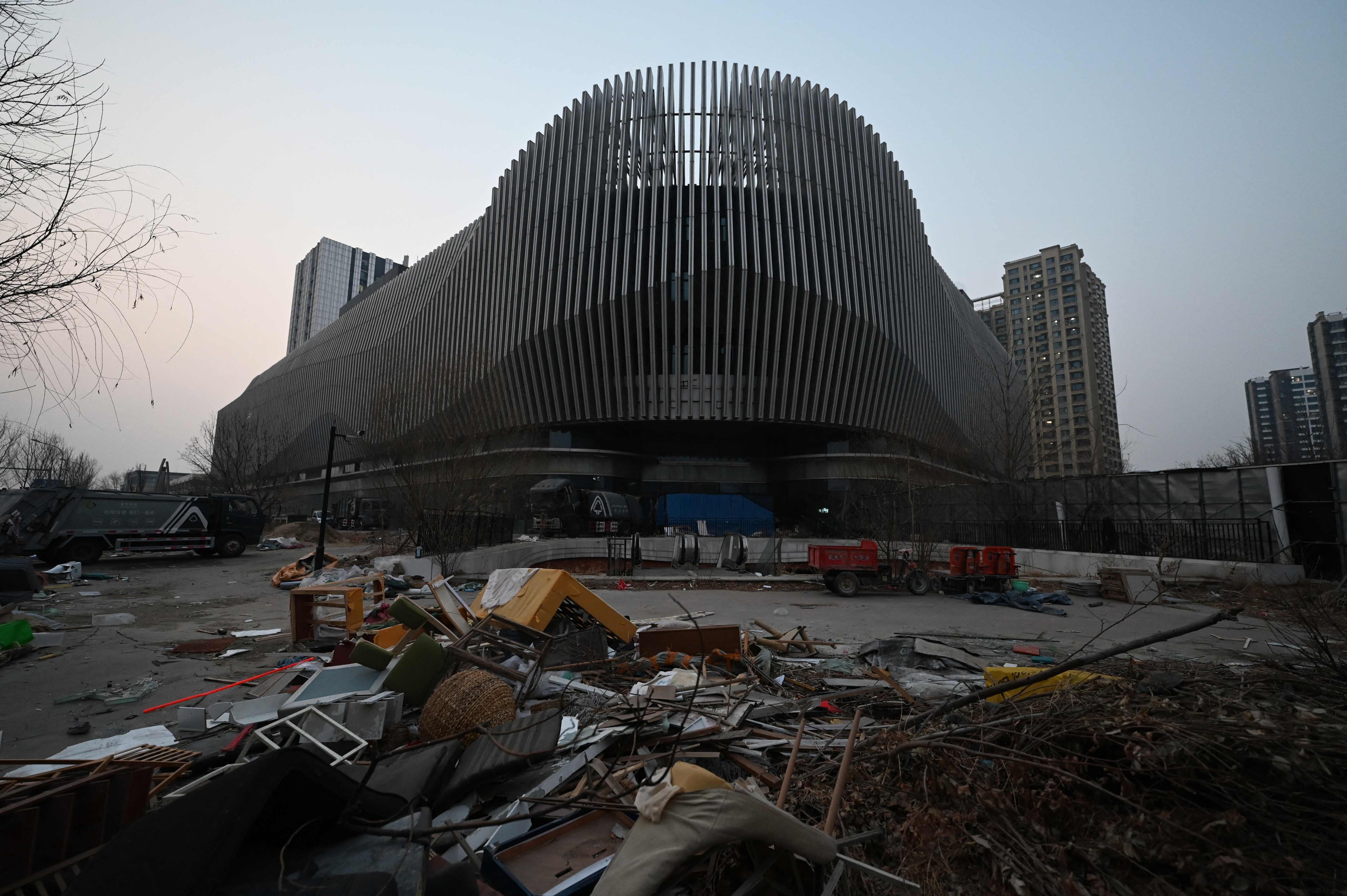 Broken furniture is seen outside an abandoned Evergrande commercial complex in Beijing on January 29, 2024. Photo: AFP