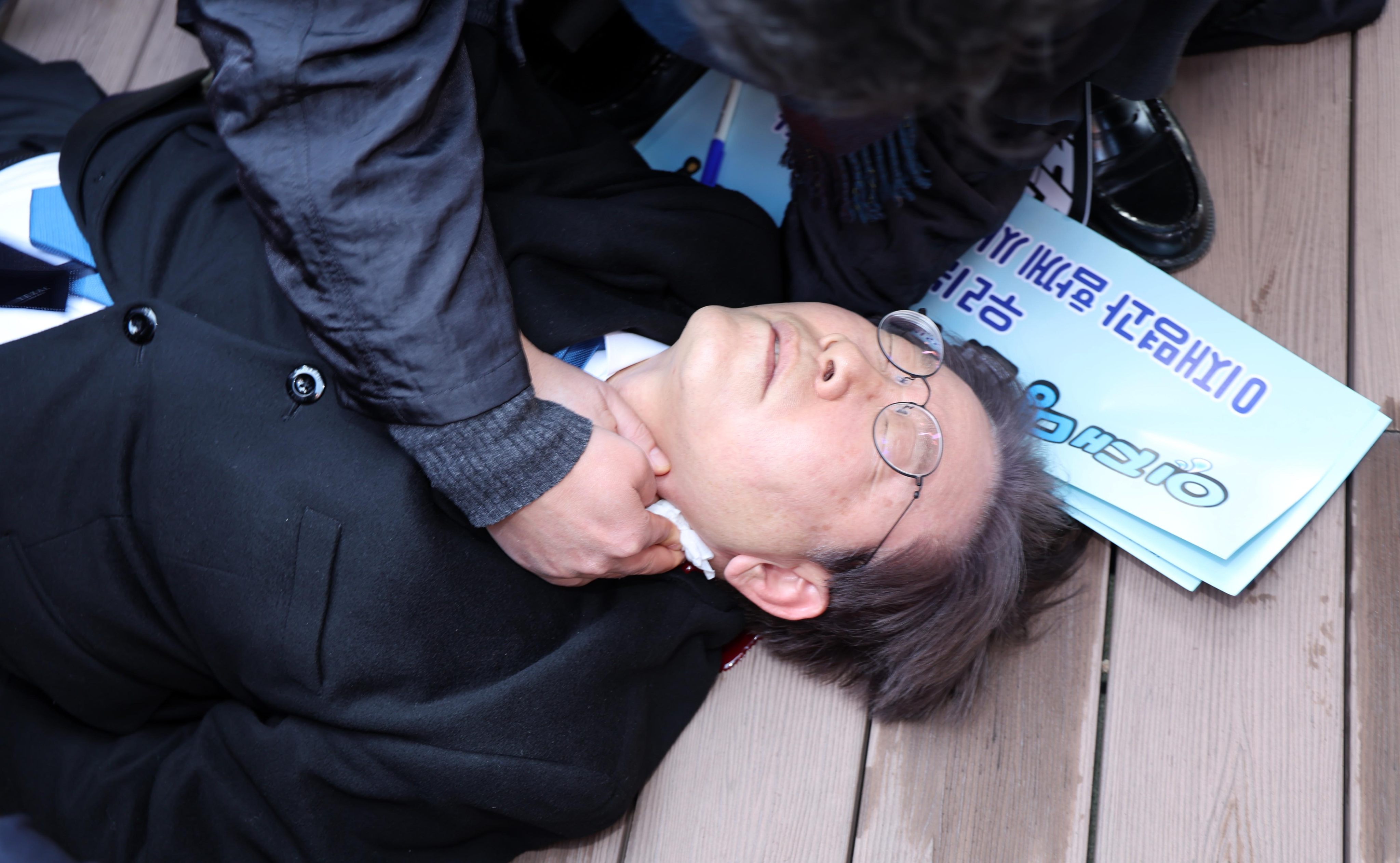 Lee Jae-myung, chief of South Korea’s main opposition Democratic Party, lies on the ground after being stabbed in the neck on January 2. Photo: Newsis via Xinhua