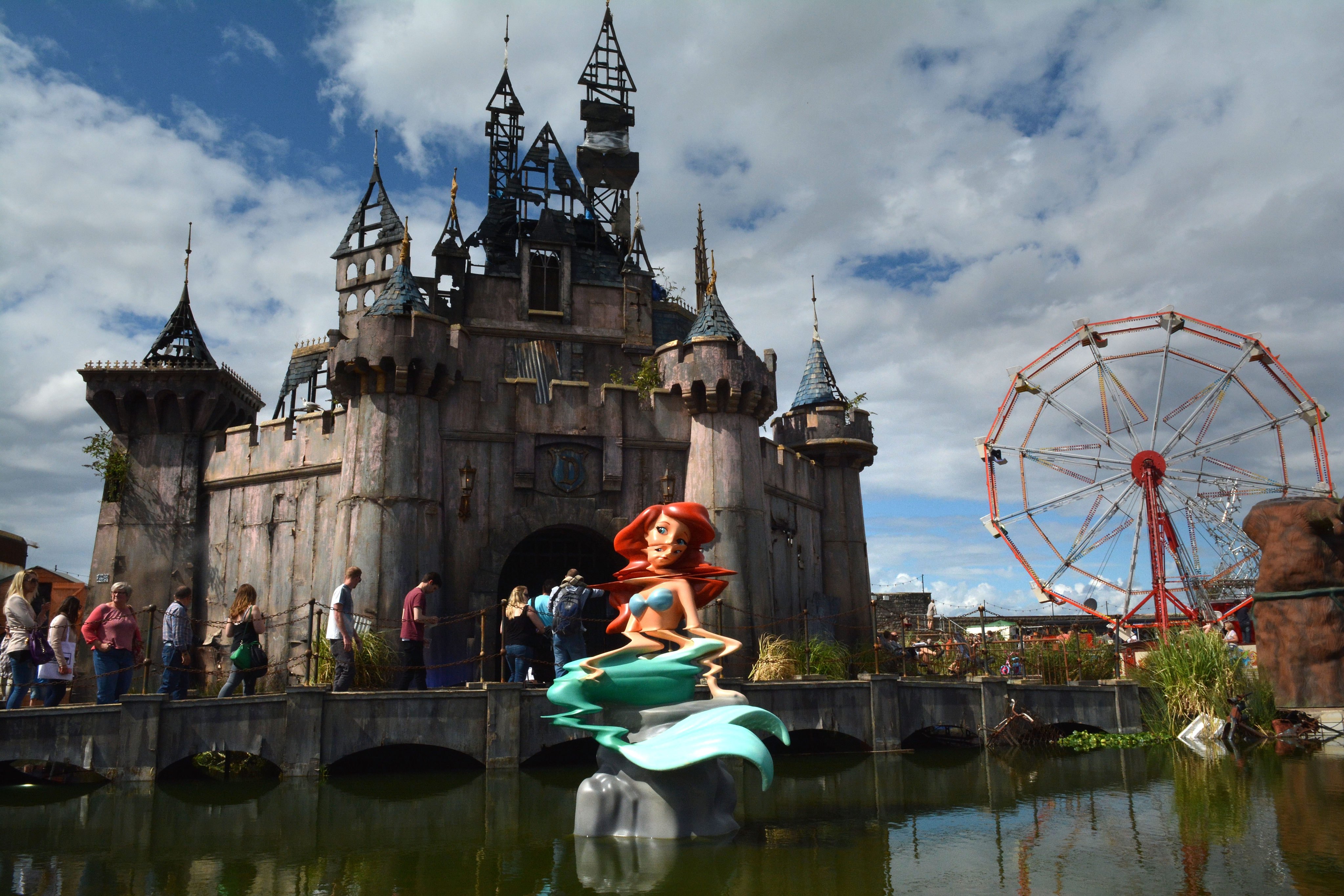 A mermaid sculpture sits in front of a fairy castle at Banksy’s Dismaland amusement park parody in Weston-super-Mare, England, in 2015. Photo: Getty Images