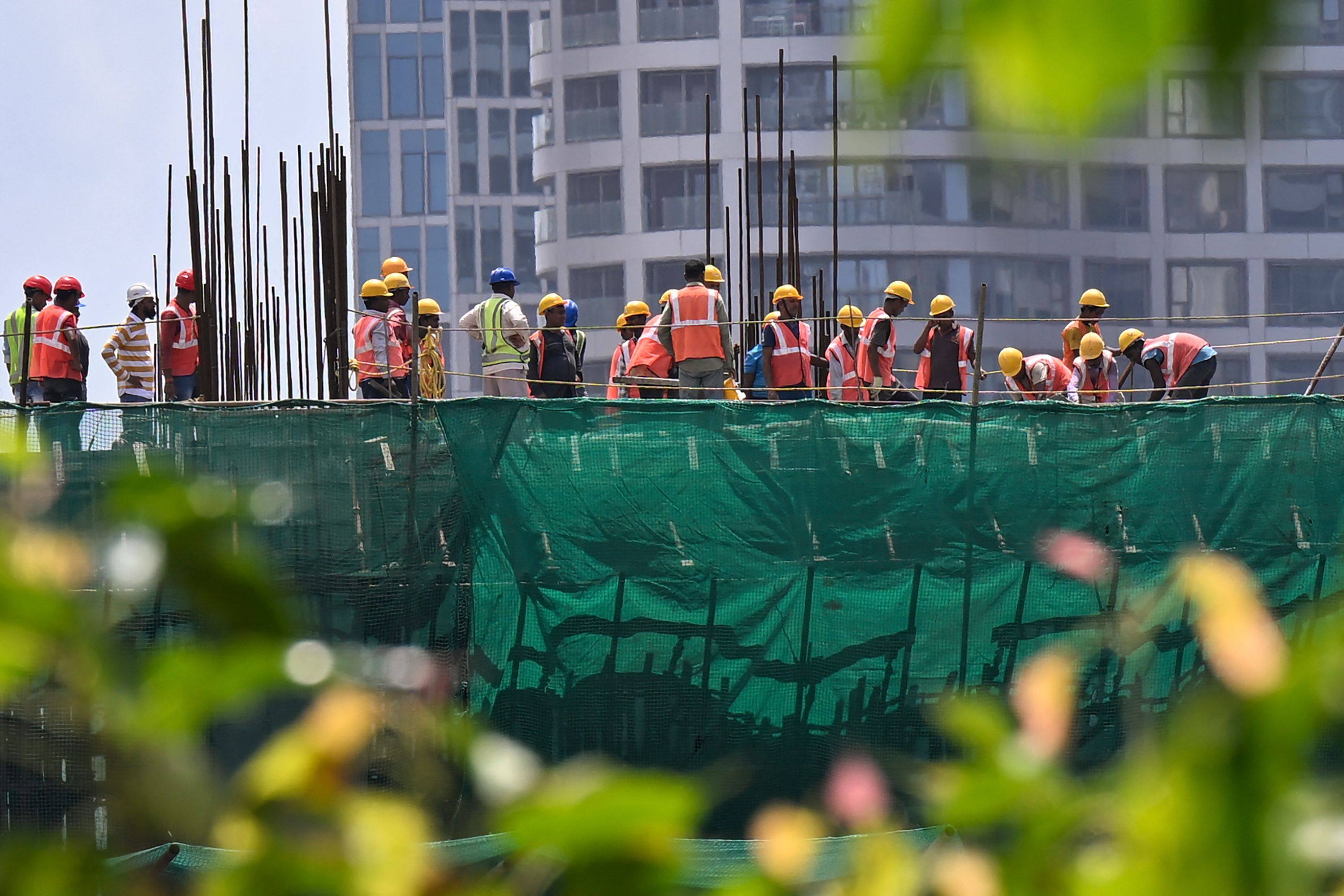Labourers work at a building site in Mumbai on September 12, 2023. While India faces major economic challenges, the property industry is going from strength to strength. Photo: AFP 