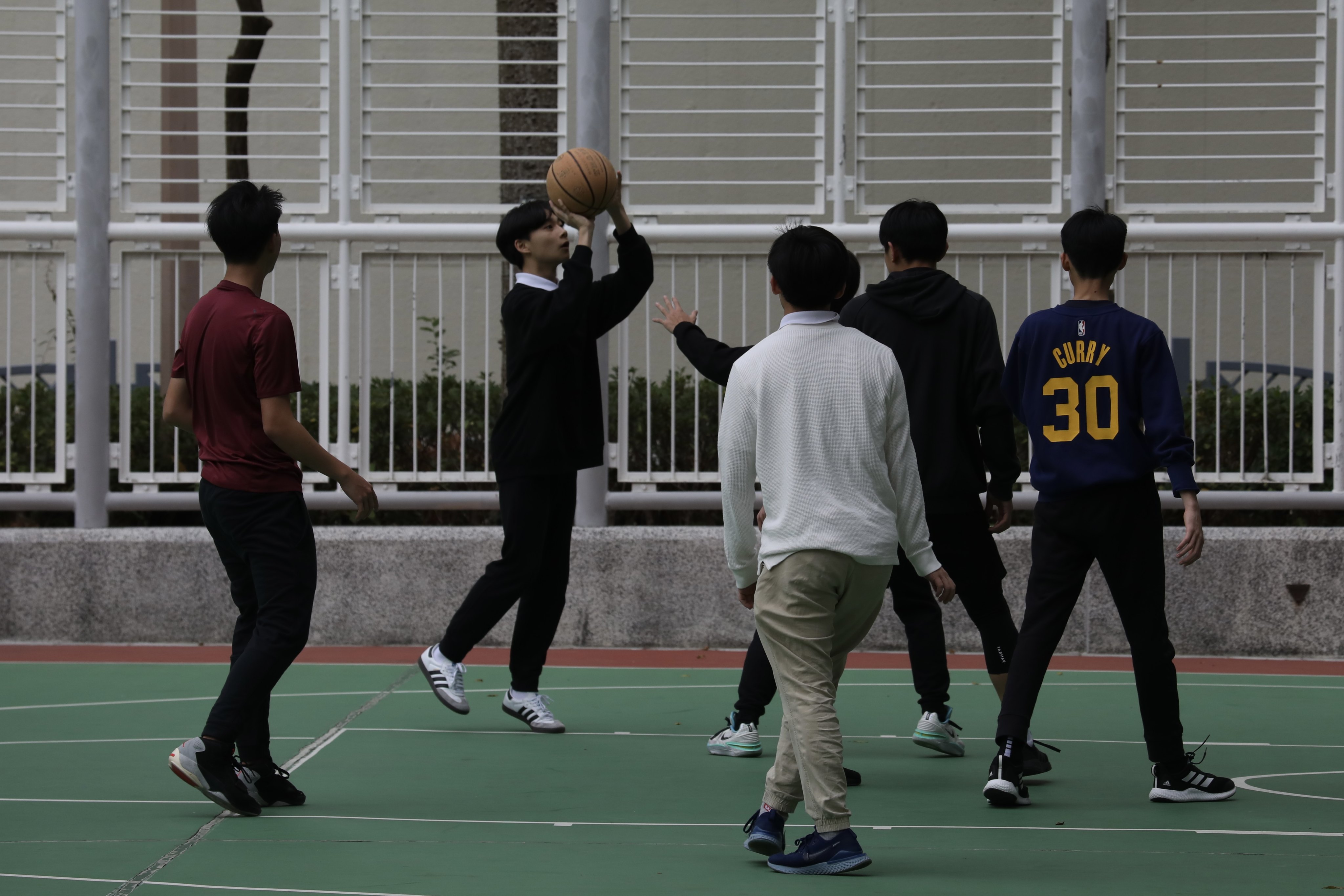 Youths play basketball in Tiu Keng Leng. The education sector  welcomed an extension to a scheme offering professional mental health support to Hong Kong pupils. Photo: Sun Yeung