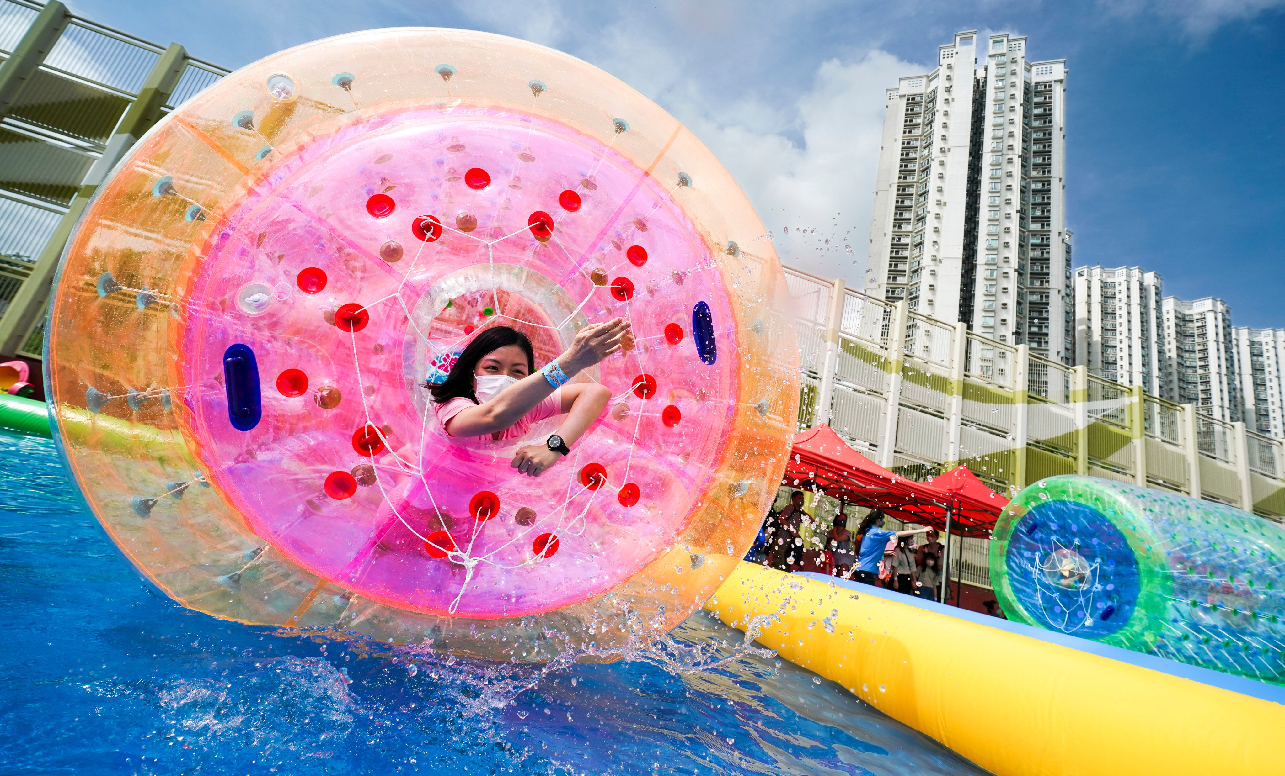 People play water games in Tin Shui Wai in 2022. Enjoyable activities around the city should be promoted in English, to make sure that expats feel included. Photo: Felix Wong
