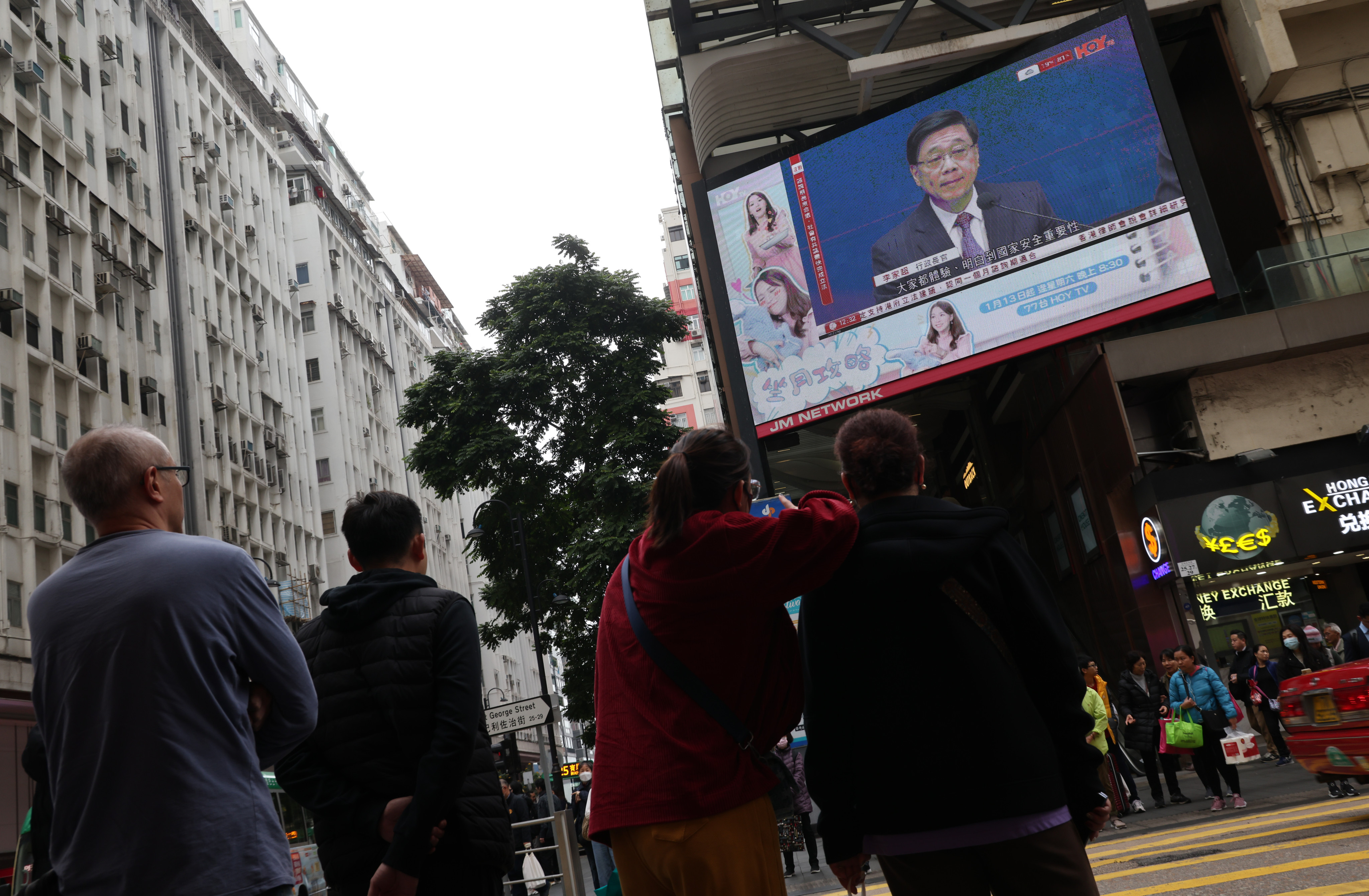 People watch city leader John Lee announce the start of the Article 23 consultation process on Tuesday. Photo: Jelly Tse