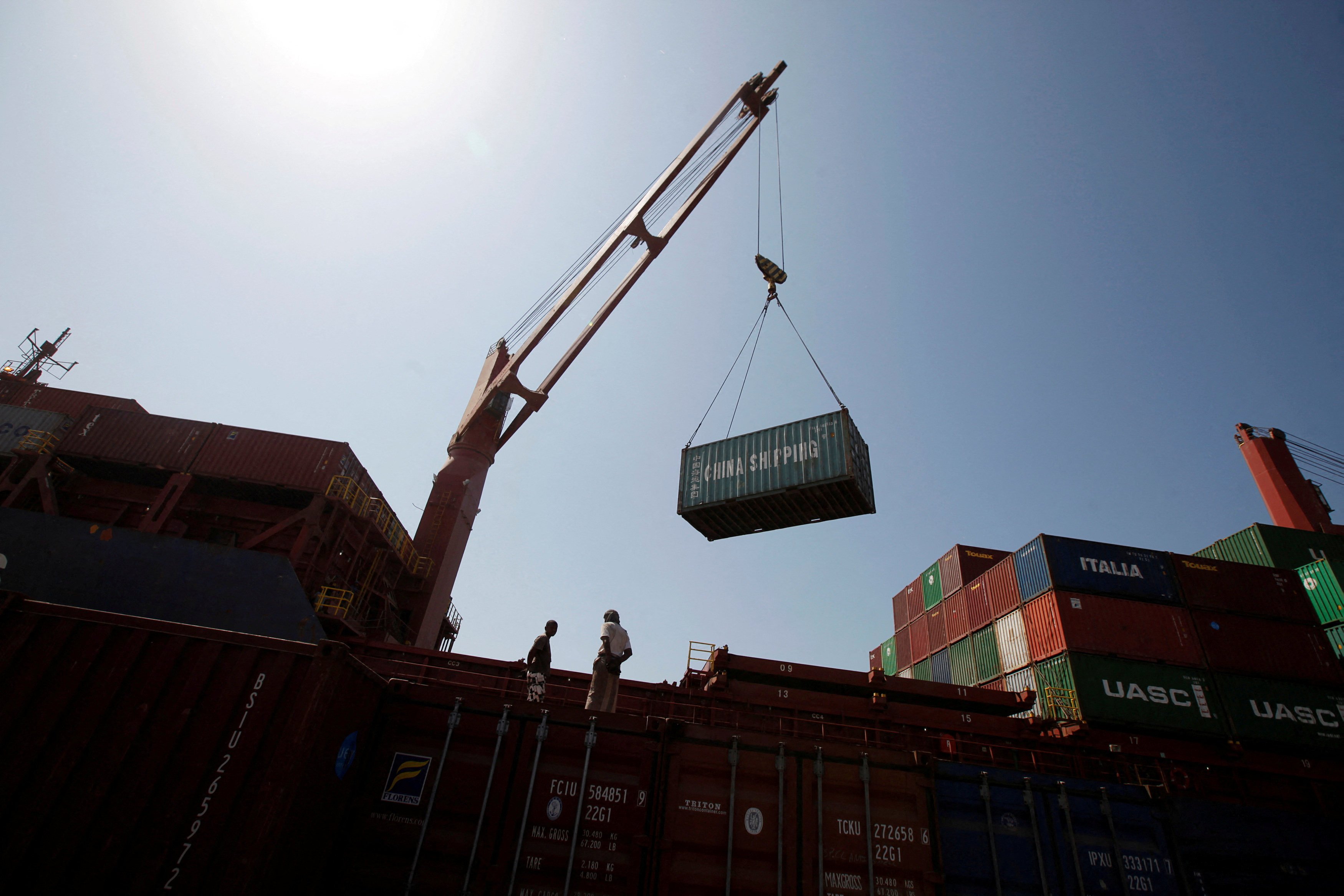 Workers look on as containers are unloaded at the Red Sea port of Hodeidah in Yemen. The Red Sea shipping crisis is sending waves through Asia’s fuel markets, hoisting costs even on routes that don’t use the waterway. Photo: Reuters